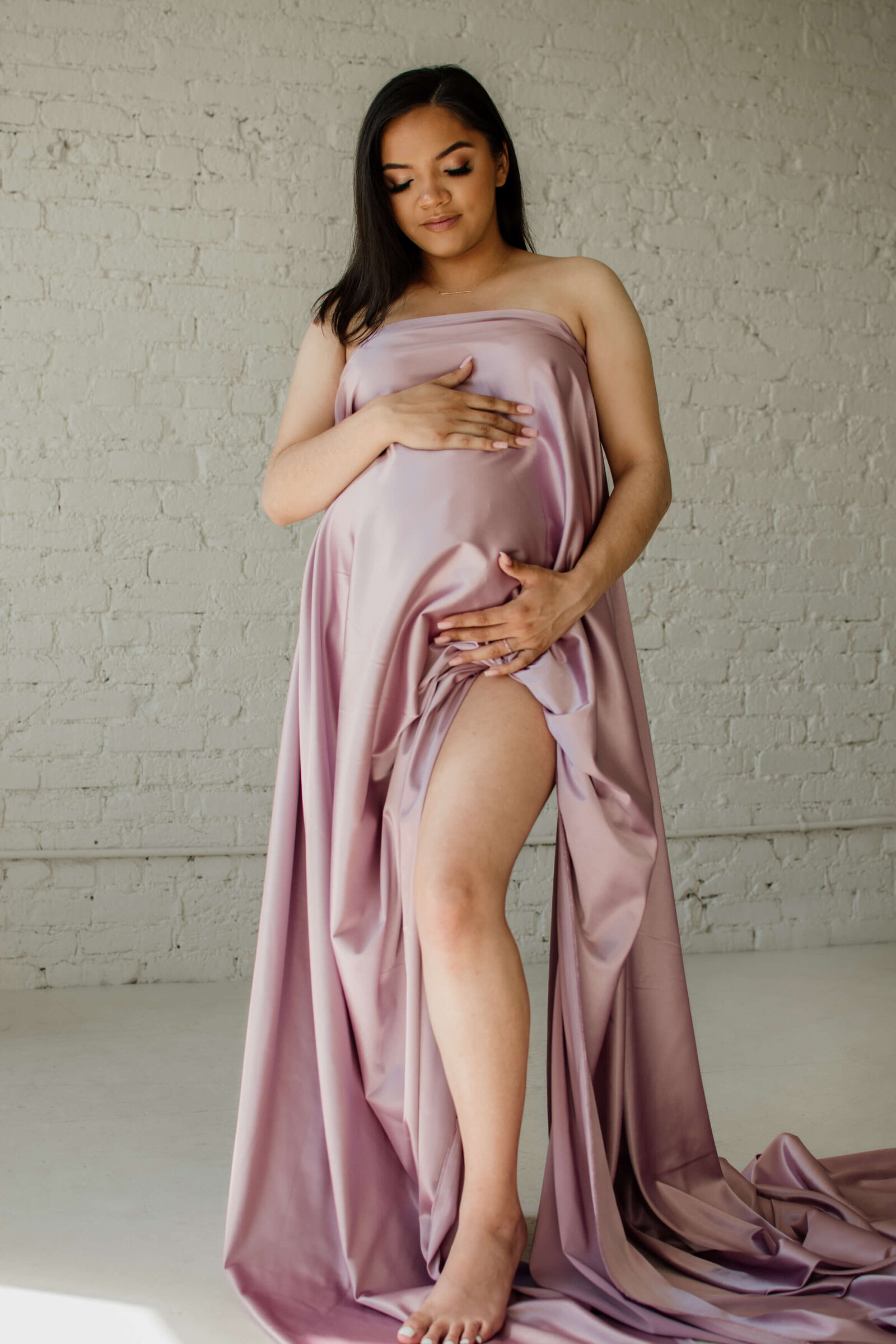 Mom-to-be draped in pink satin.