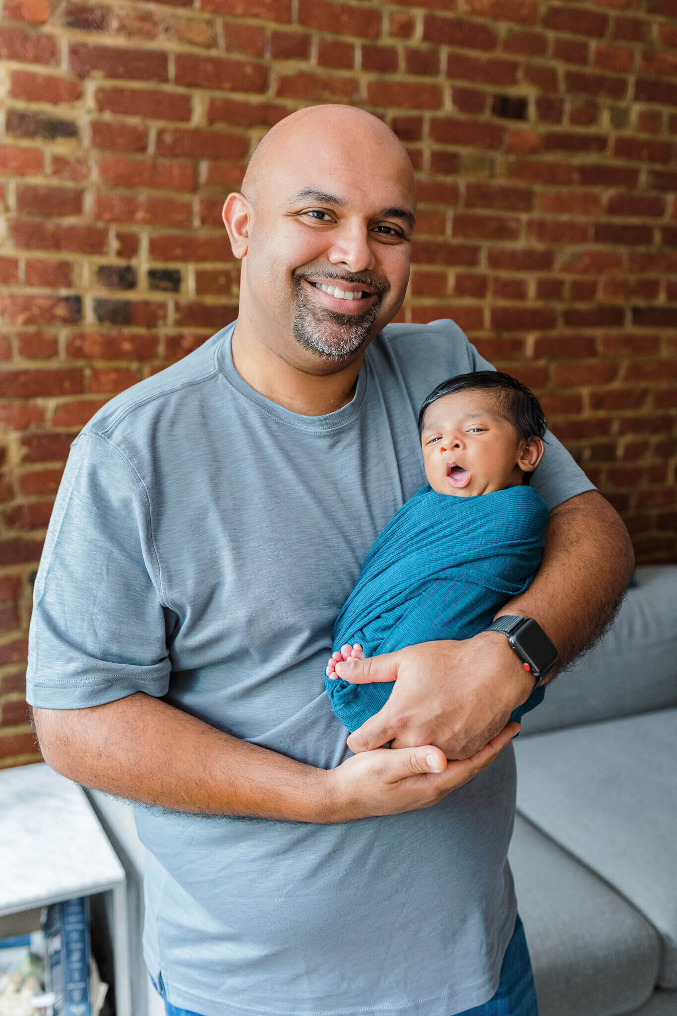 A dad holding his newborn son in their Northern Virginia home.