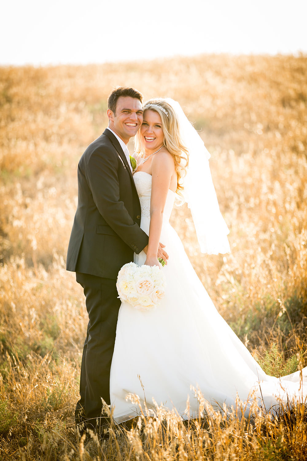 rustic field with bride and groom