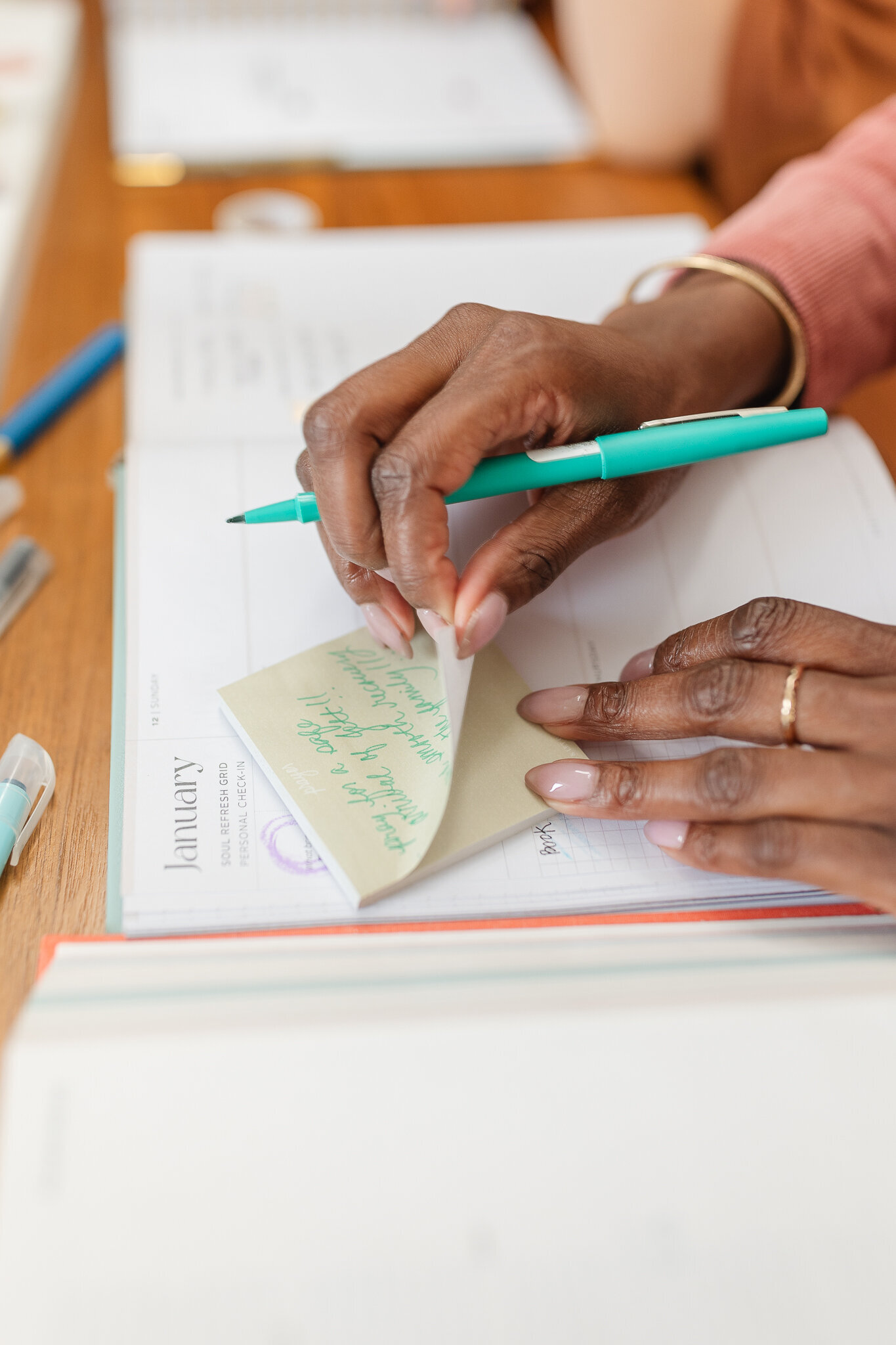 a woman peels a sticky note 