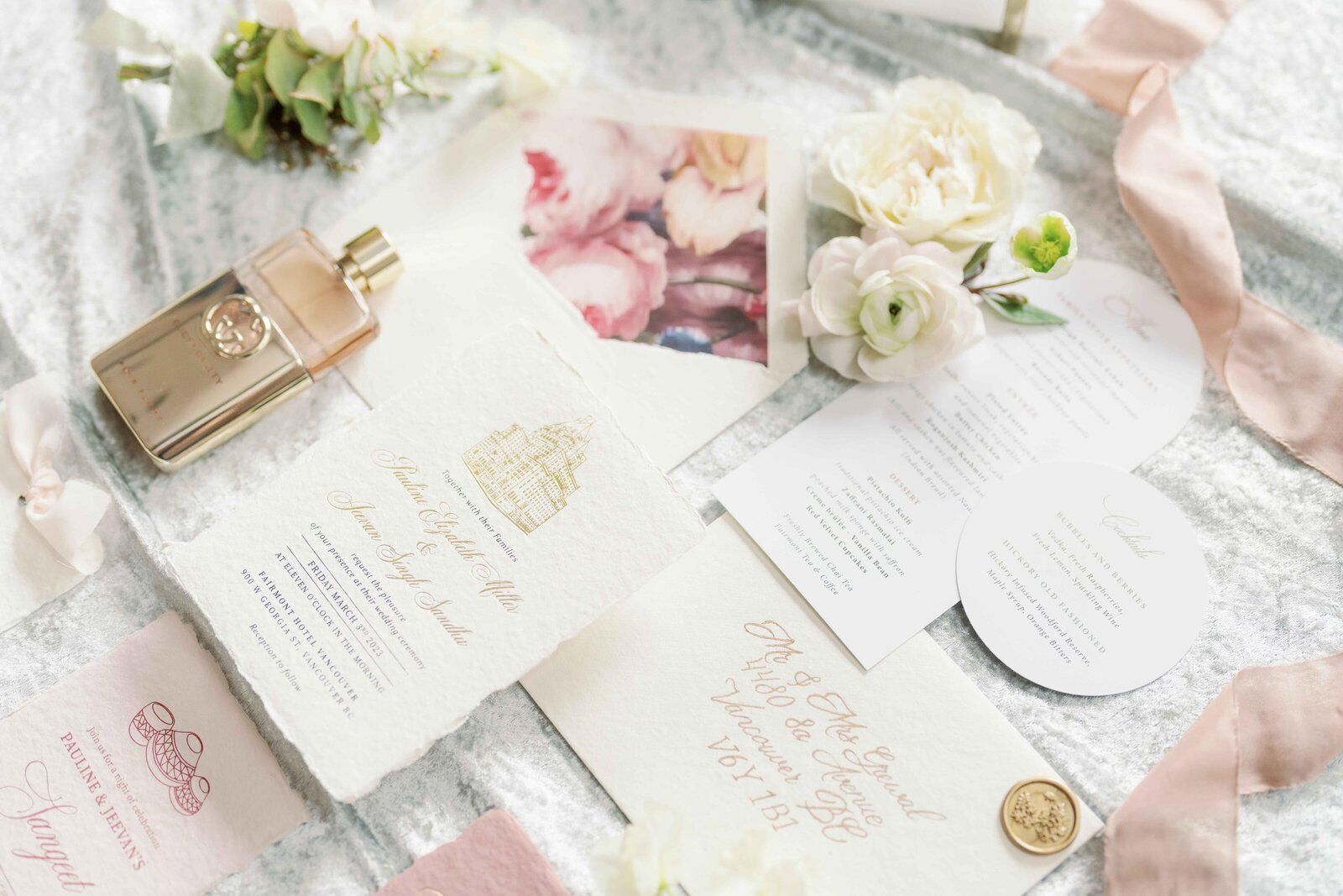 white and gold wedding plating with the letters J and M engraved on the plates