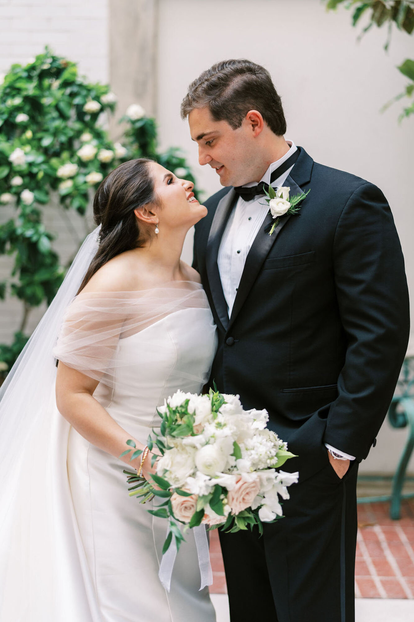bride and groom smiling at each other
