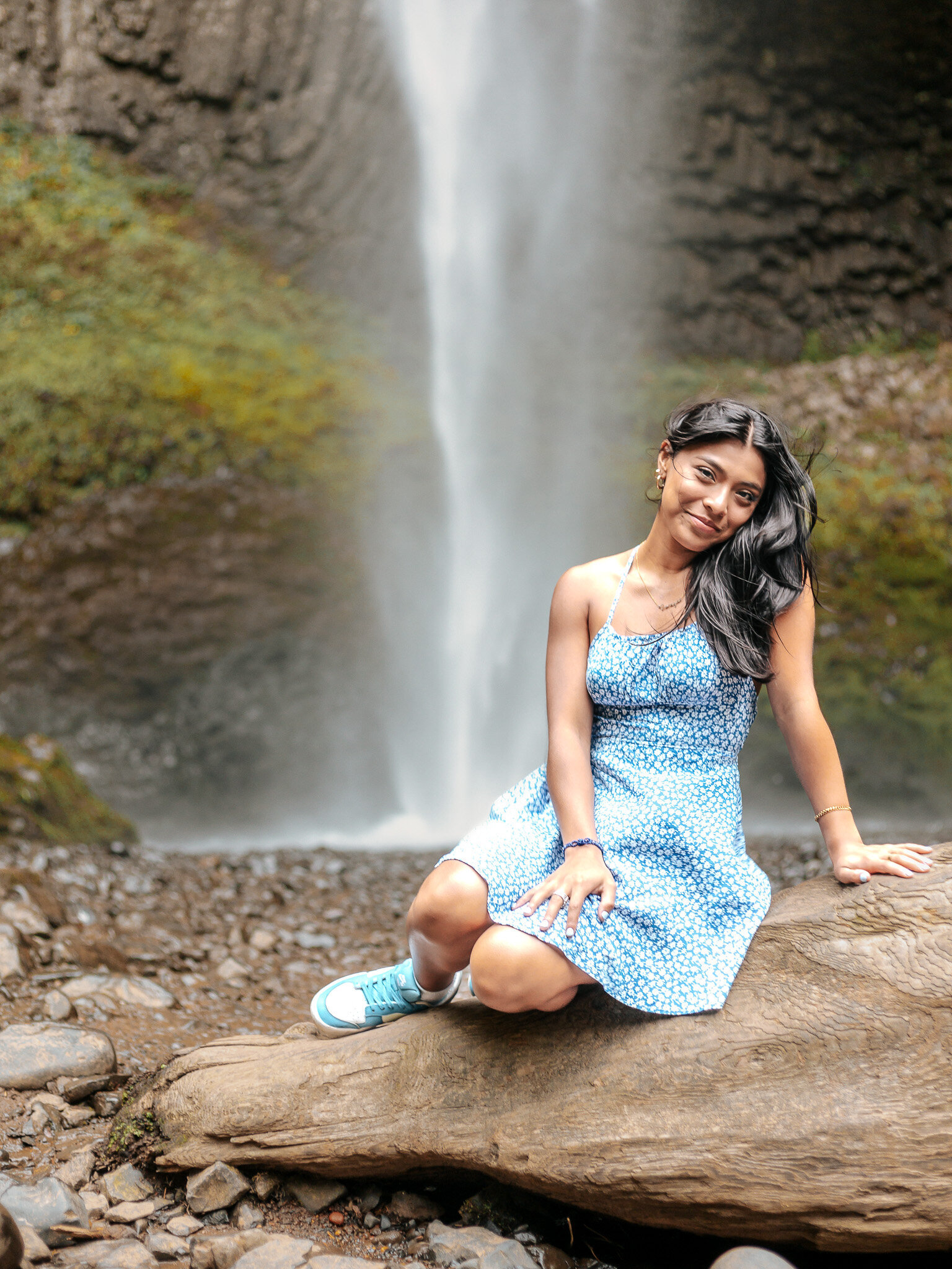 Girl sitting by a waterfall in the columbia river gorge
