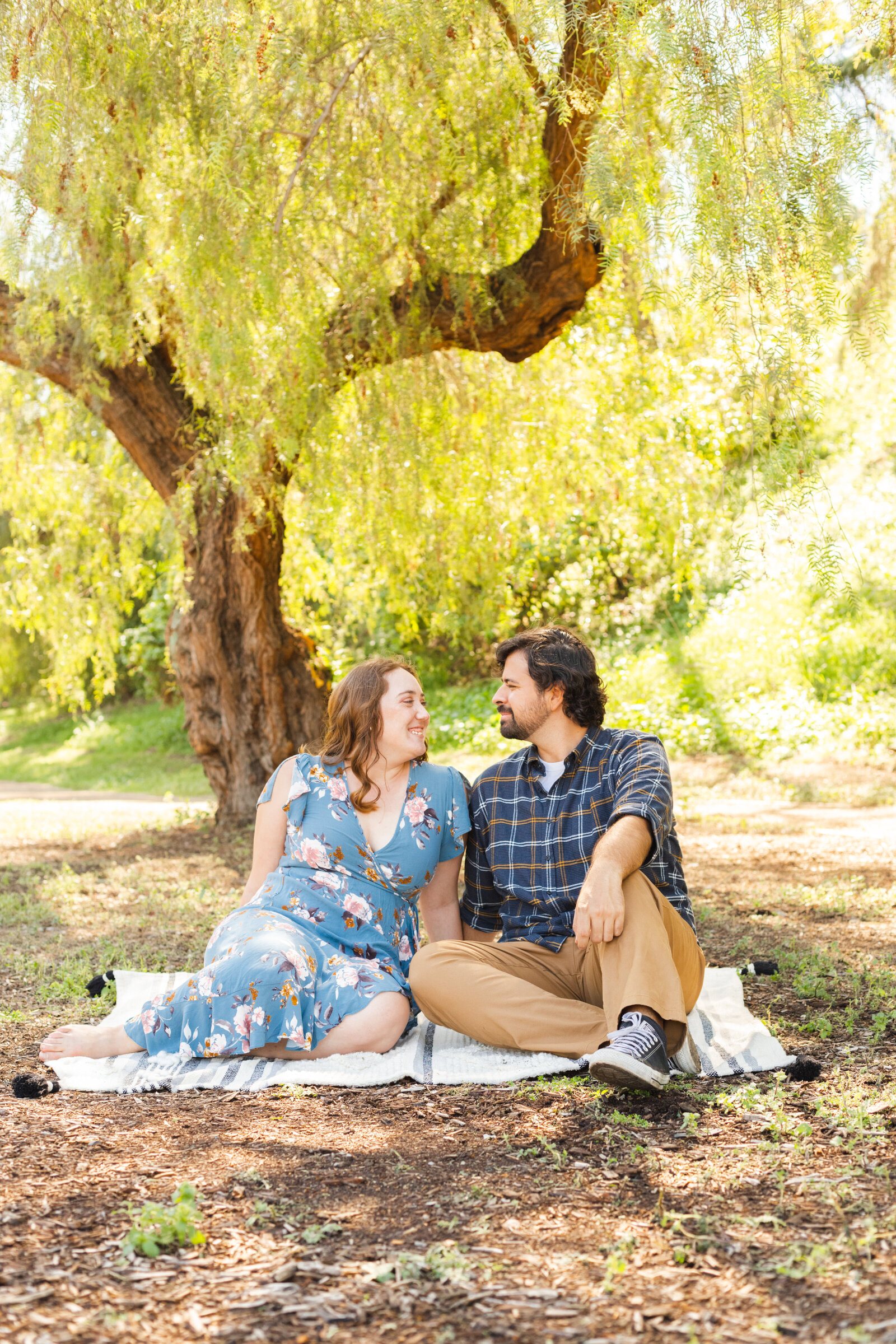 An engaged couple poses for photos in a garden in Los Angeles, Ca.