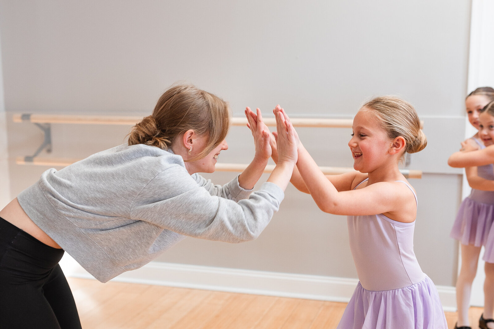 a dance teacher high fives their student