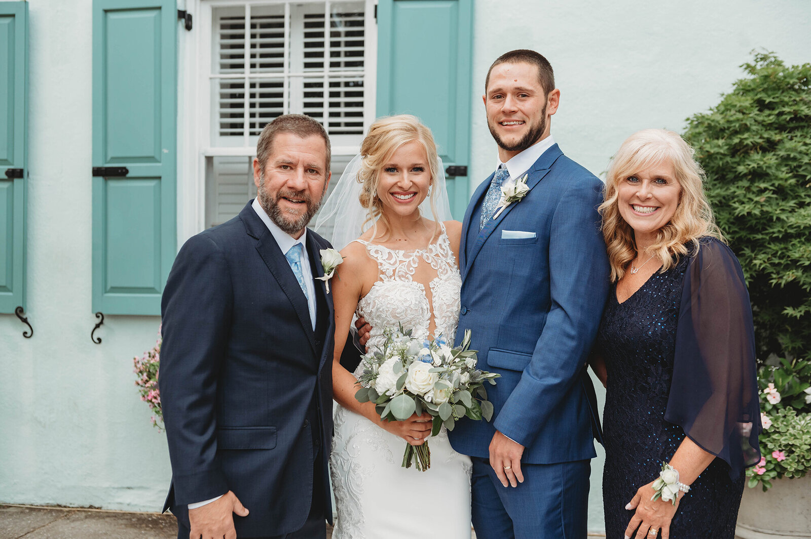 Newlyweds pose with parents of the bride after their Micro-Wedding Ceremony in Charleston, SC.