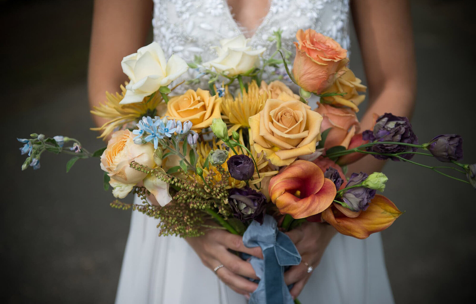 orange a blue bouquet held by a bride