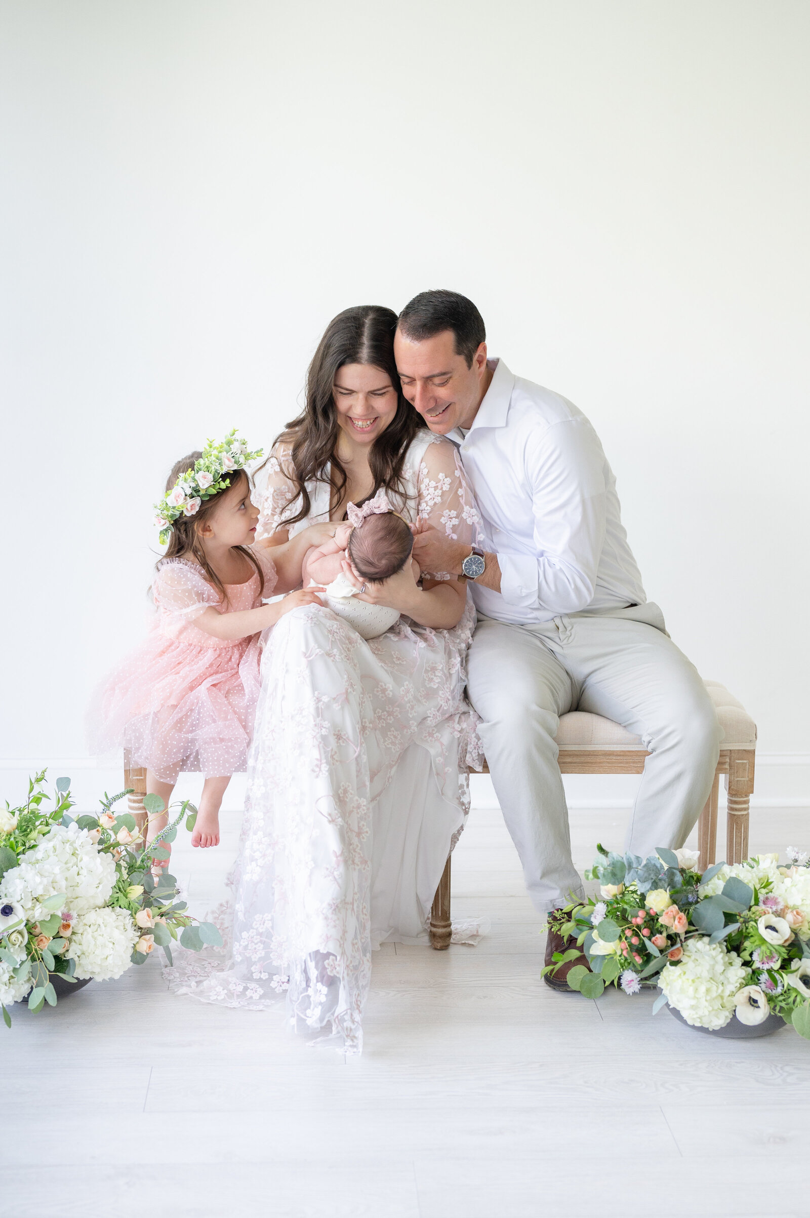 Family looking at newborn baby taken by Apex Newborn Photographer