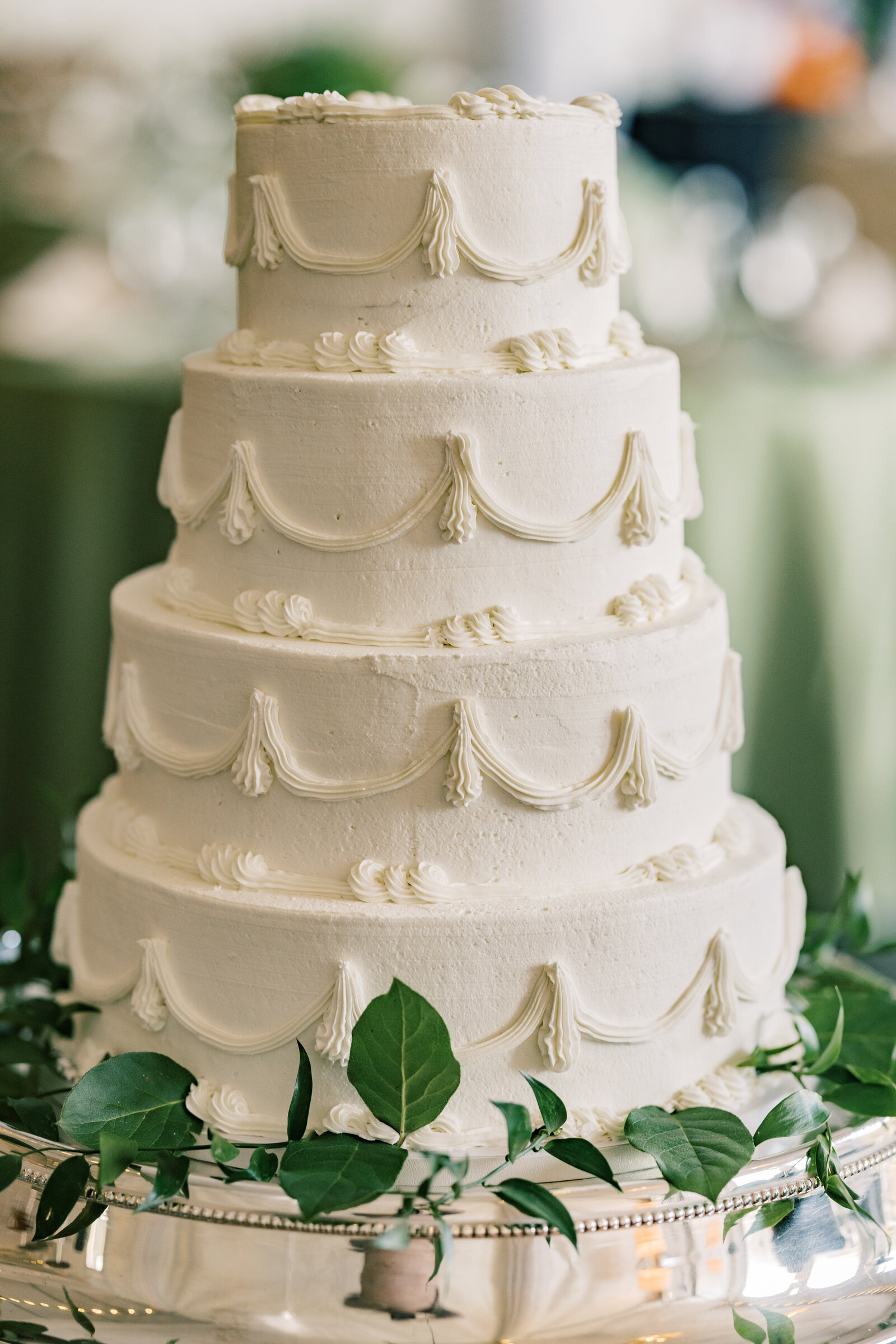 A beautifully designed wedding cake at Inola in Blue Ridge, GA, featuring exquisite floral accents and elegant craftsmanship, adding charm to the celebration.