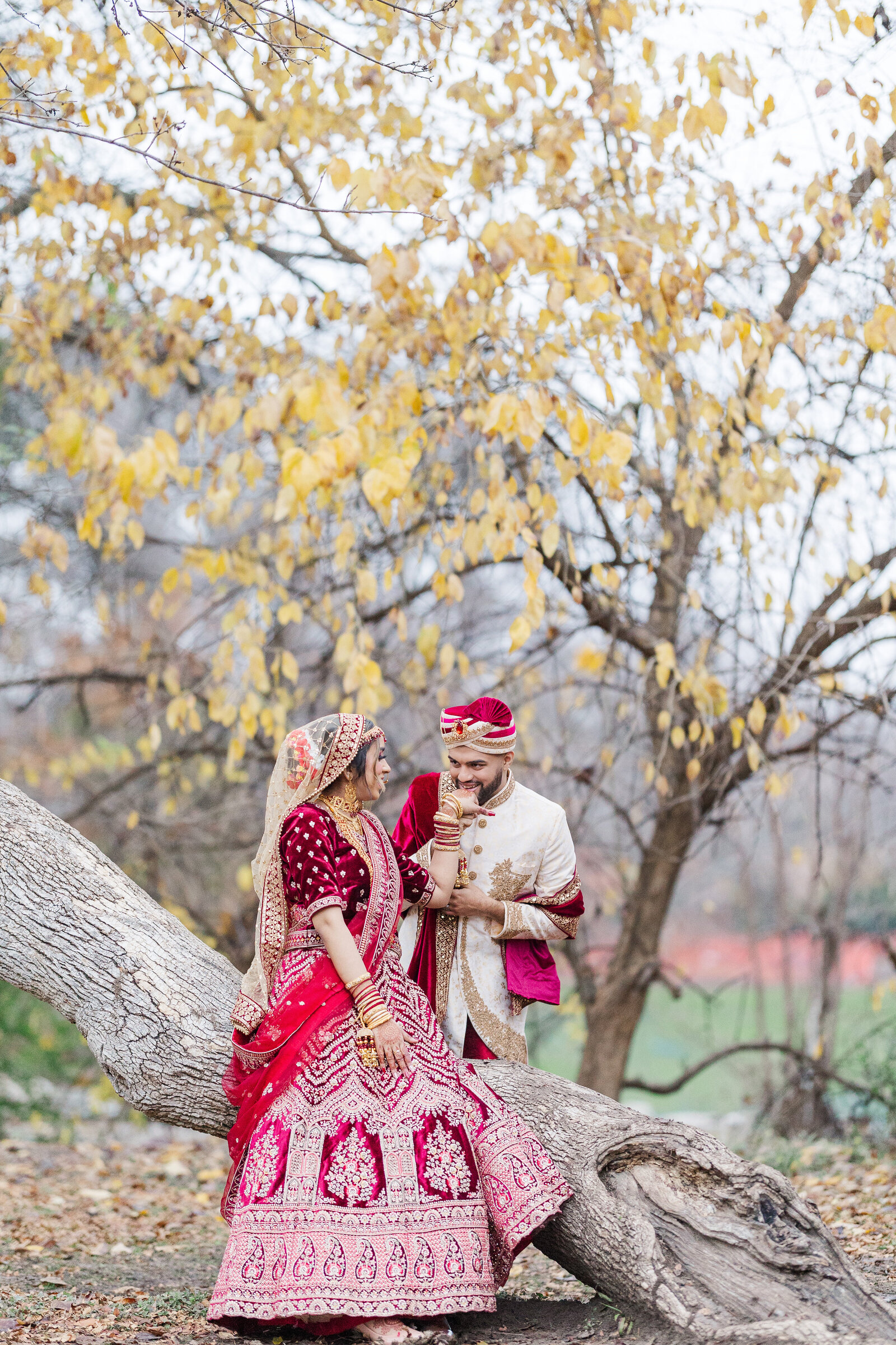 Groom-kissing-bride-hand-outdoor-photoshoot