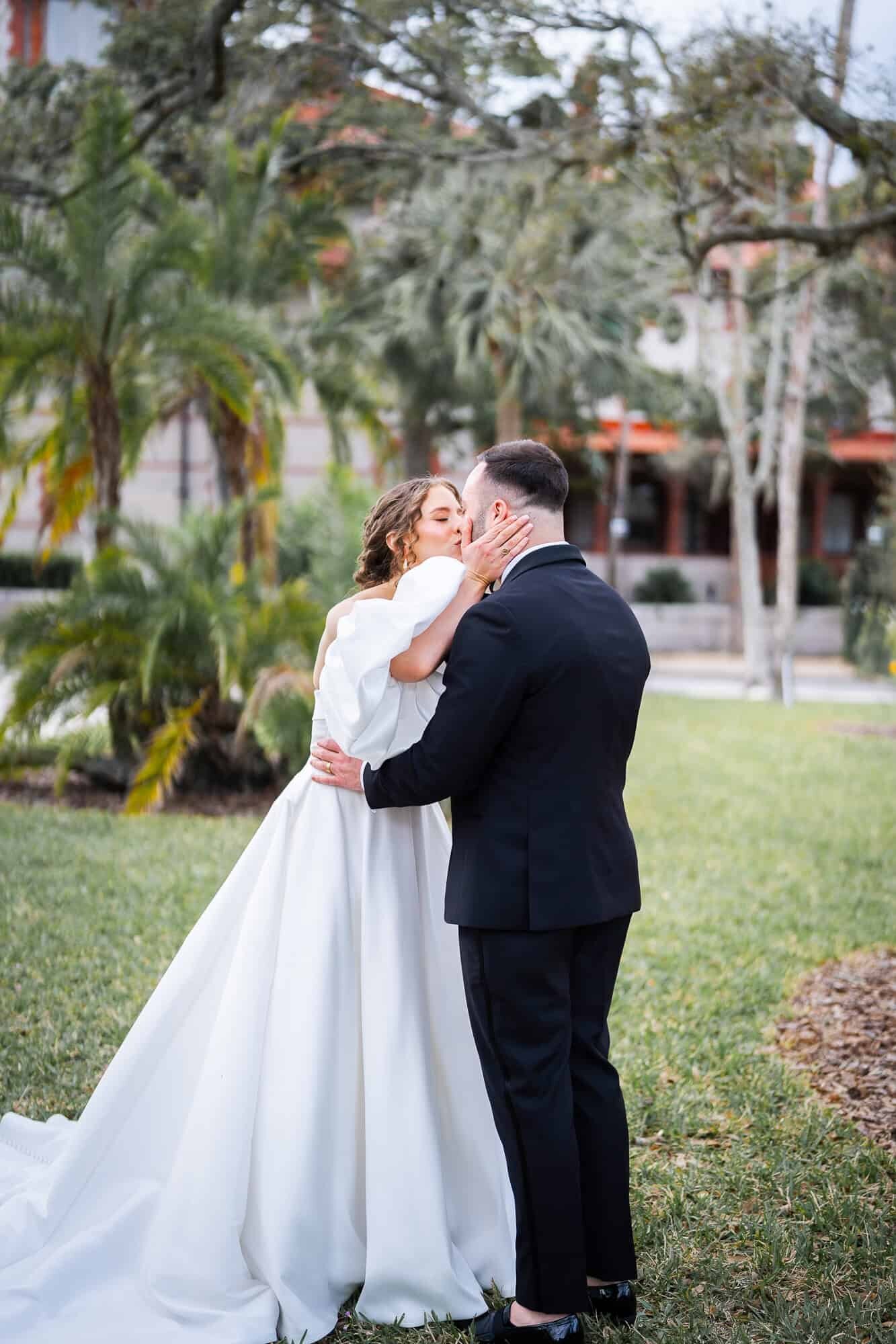 Bride kissing groom first look at Casa Monica Wedding venue in St Augustine