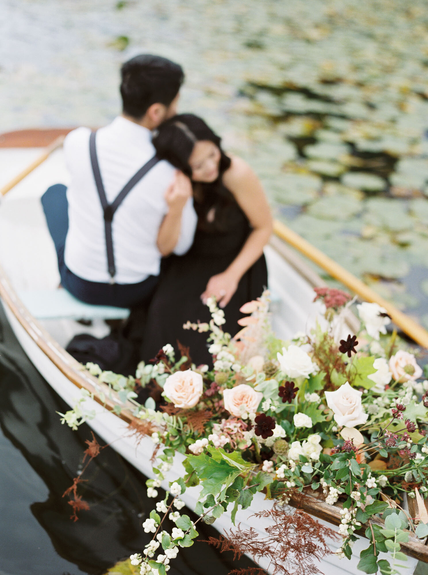 Bride and groom in a boat on a lake