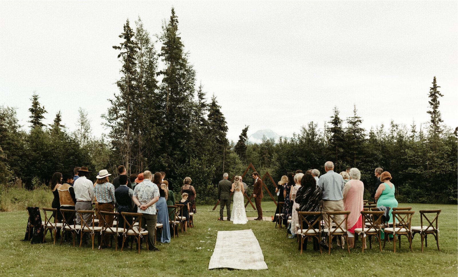 couple surrounded by family and friends during their wedding ceremony in Palmer, Alaska