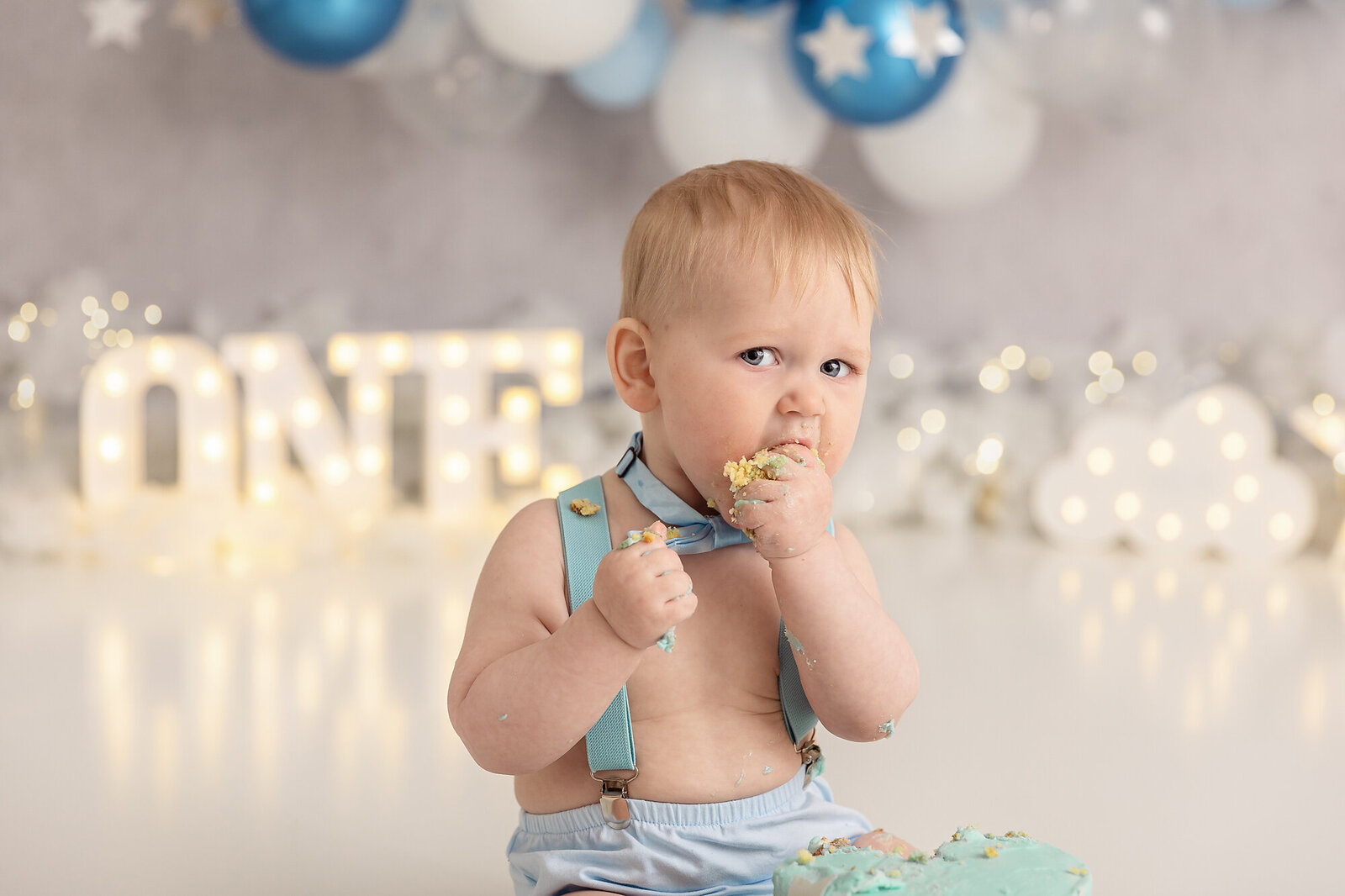 baby boy eating cake by milestone photographer new philadelphia