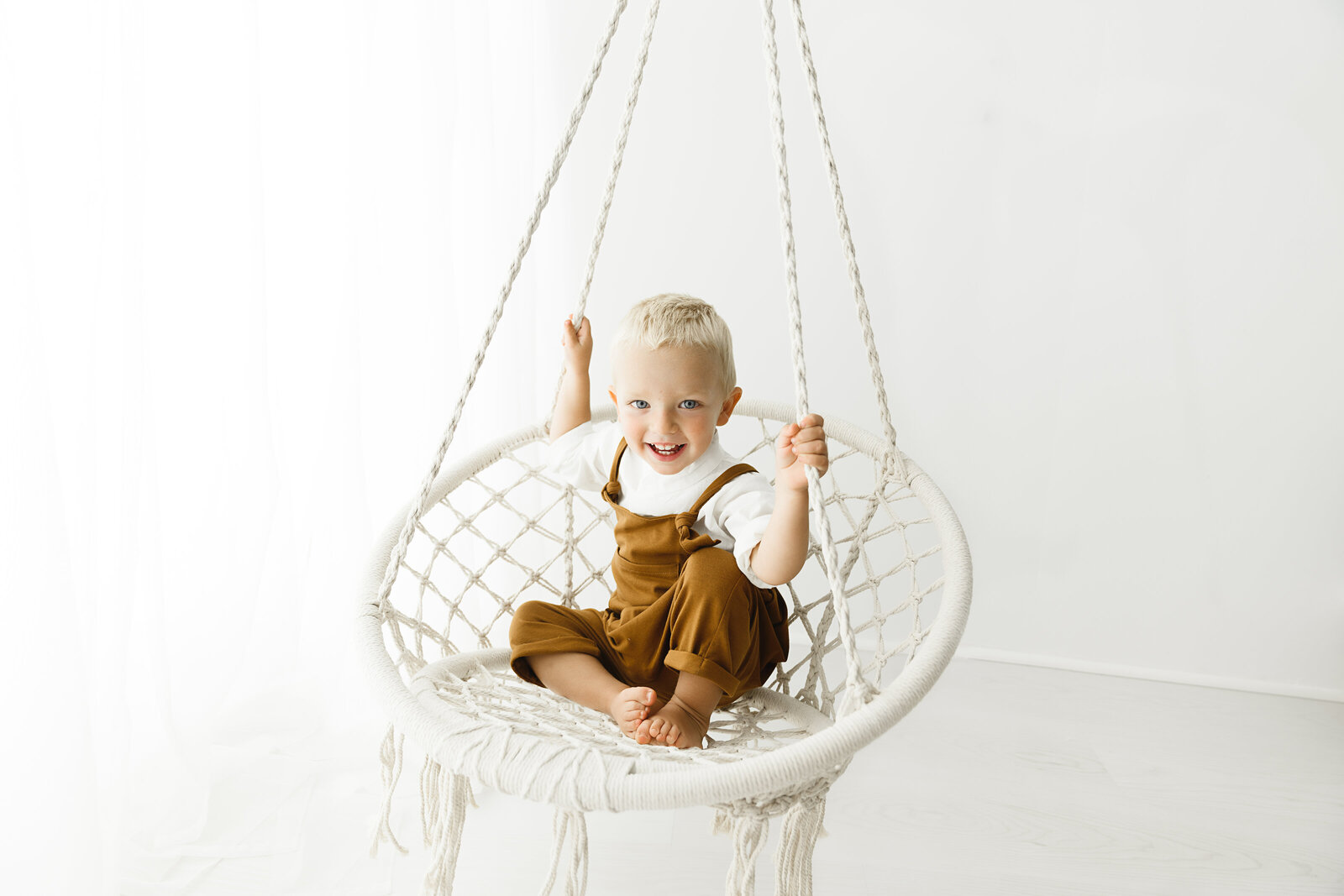 toddler in rope swing