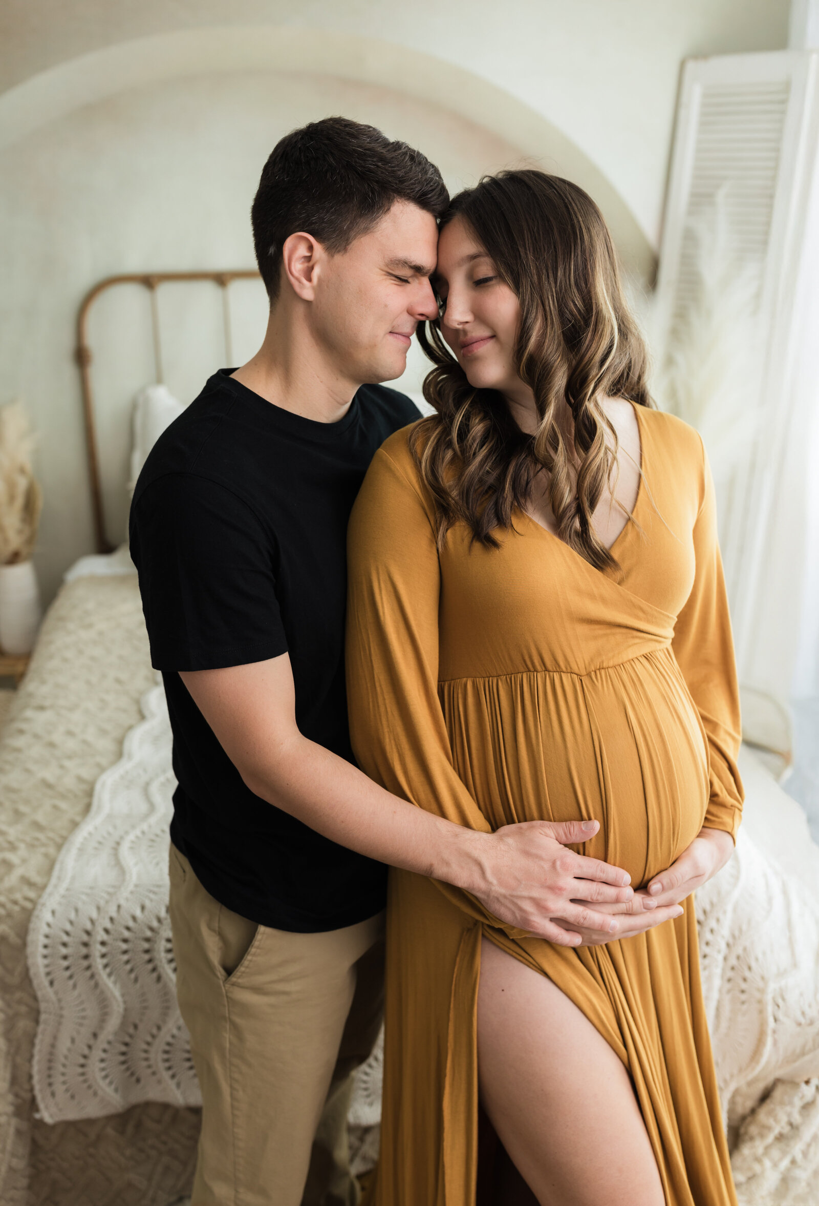 husband and pregnant wife holding baby bump for maternity studio portraits cleveland maternity photographer