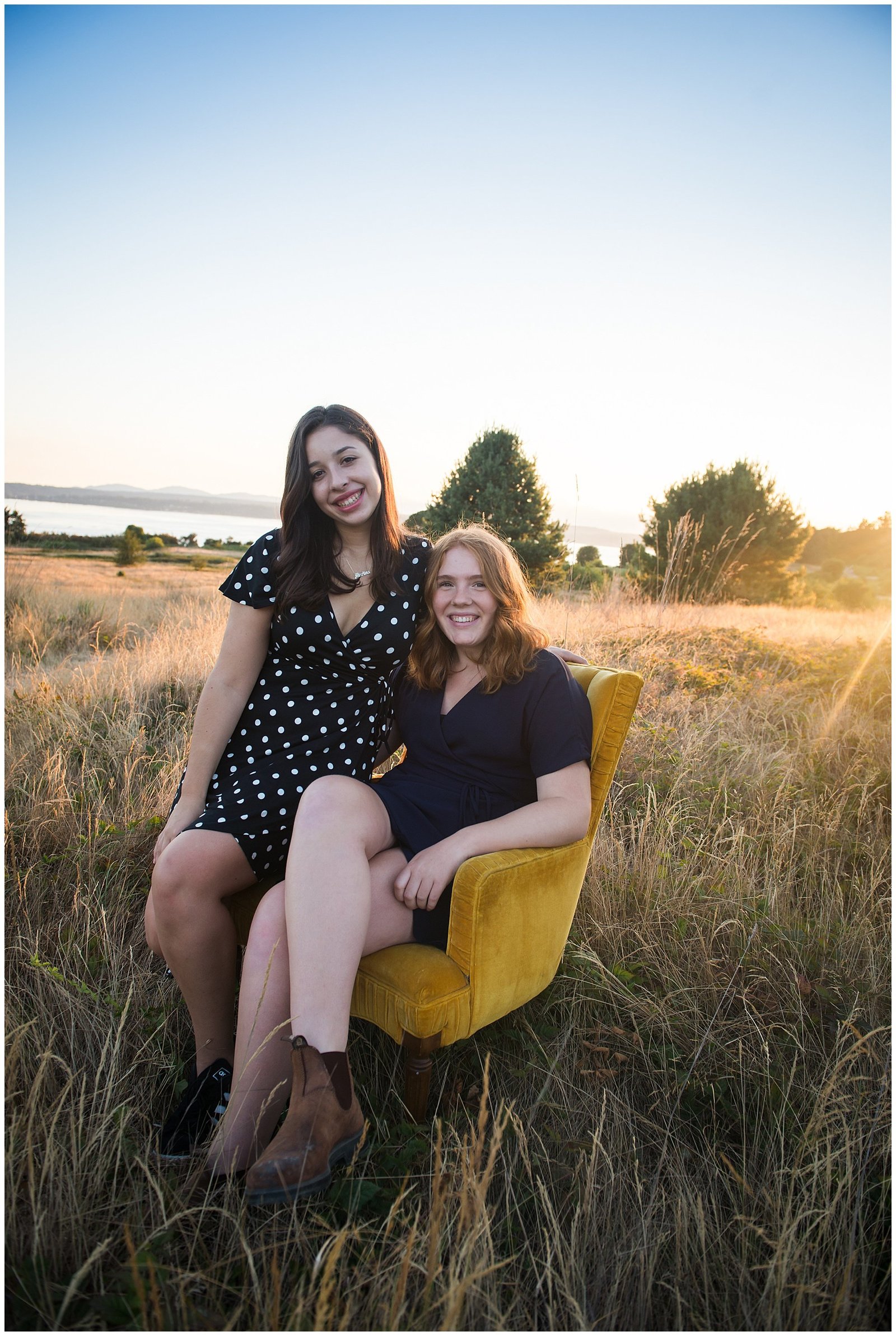 Two senior graduation girlfriends in yellow chair at sunset Emily Ann Photography Seattle Photographer
