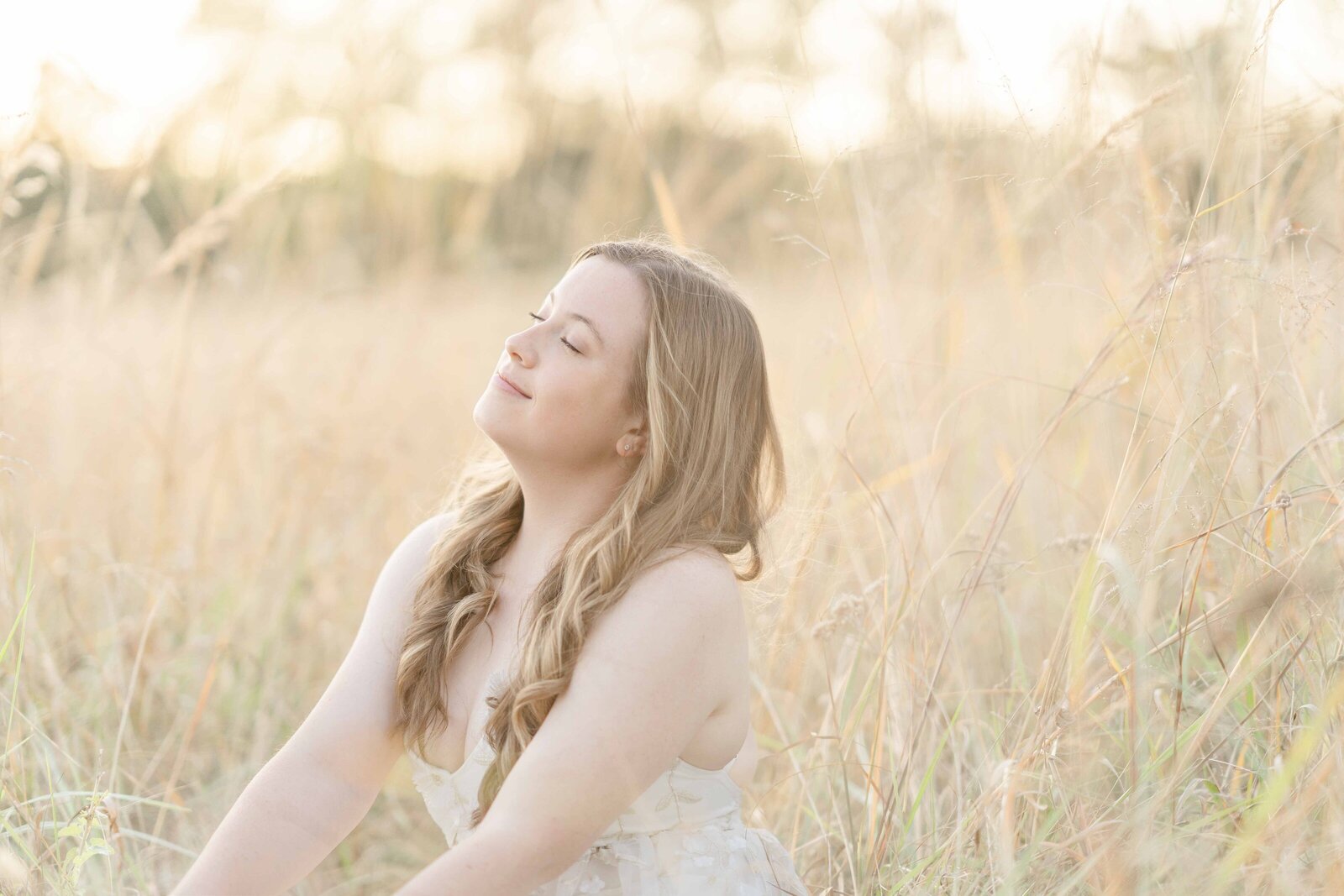 girl closed her eyes to soak the moment in during Ashburn, Virginia senior photo