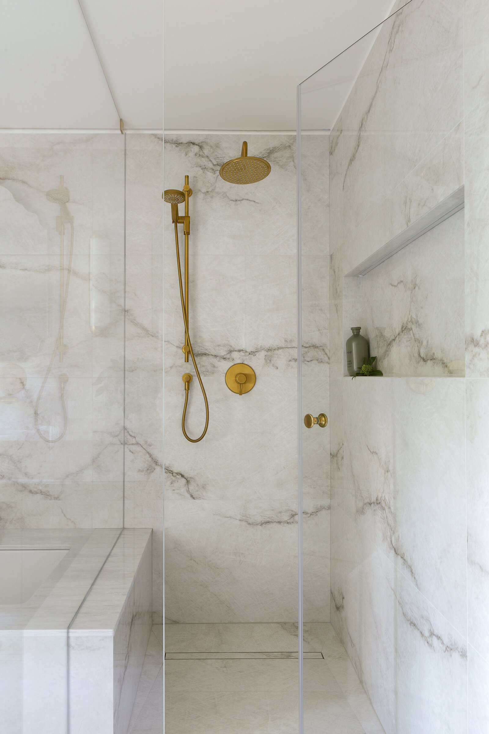 Contemporary washroom design featuring modern hardware and artful marble 