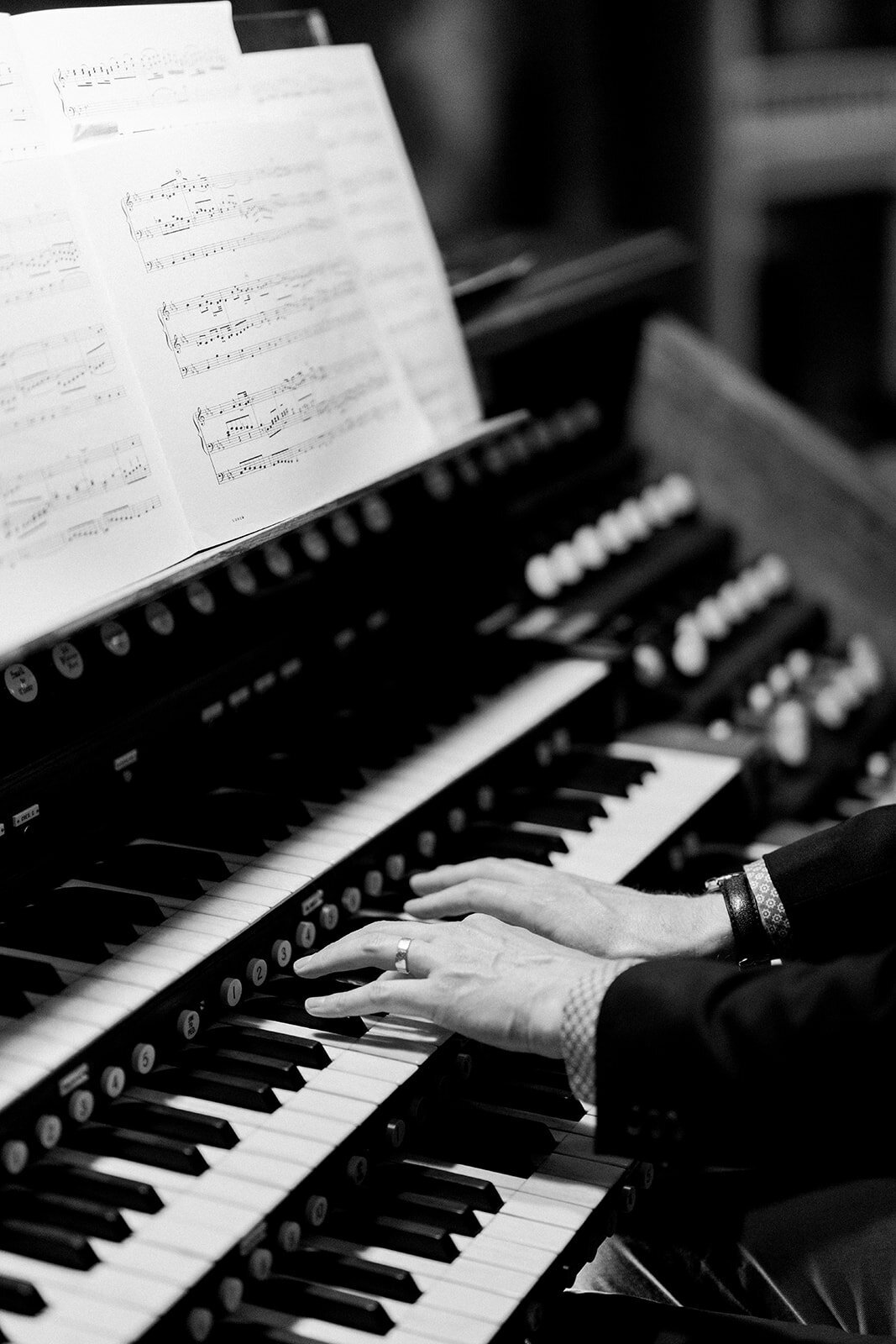 An organist playing during a wedding ceremony at Stanford Memorial Church, adding to the elegant ambiance of the event.