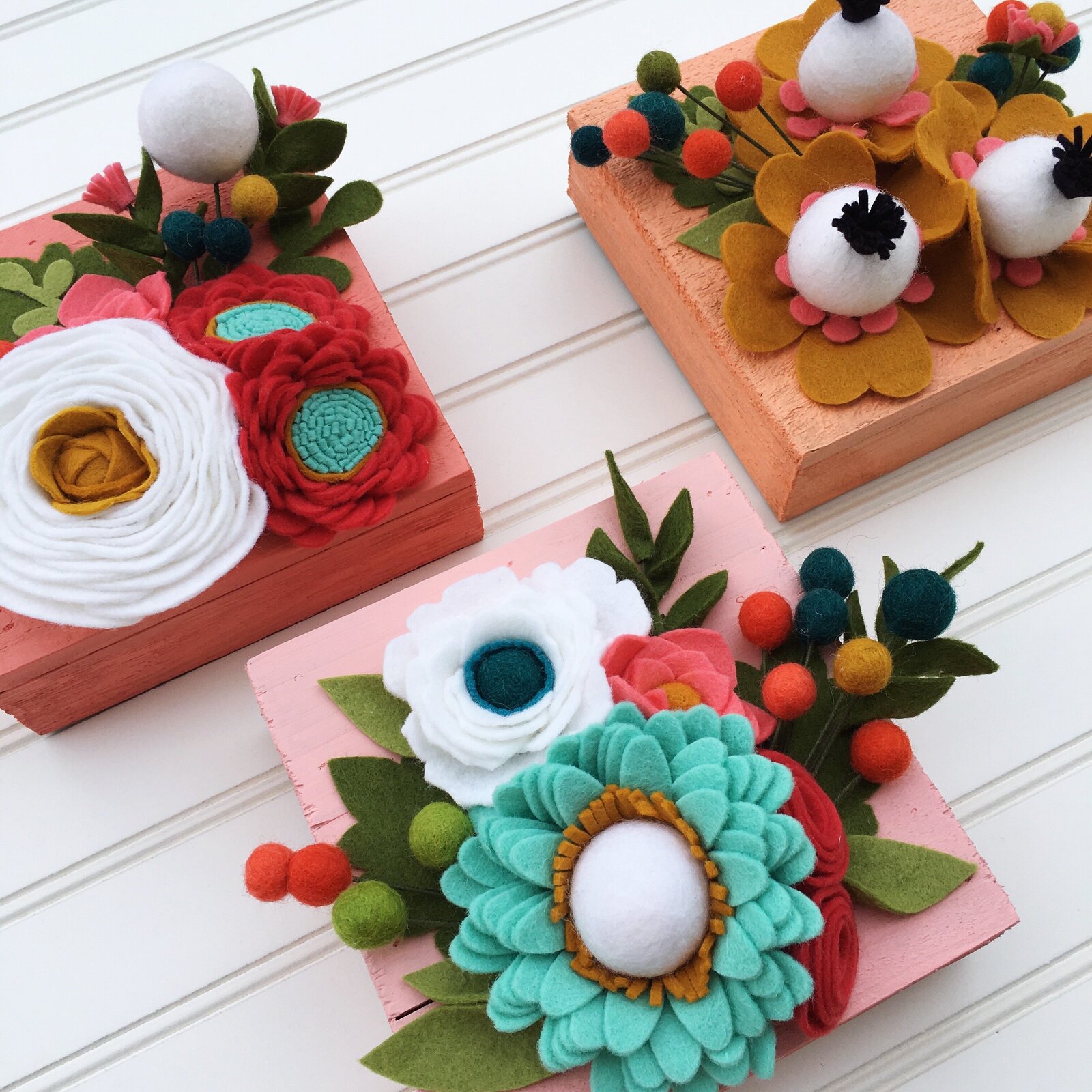 Felt flower set of three wall hangings.