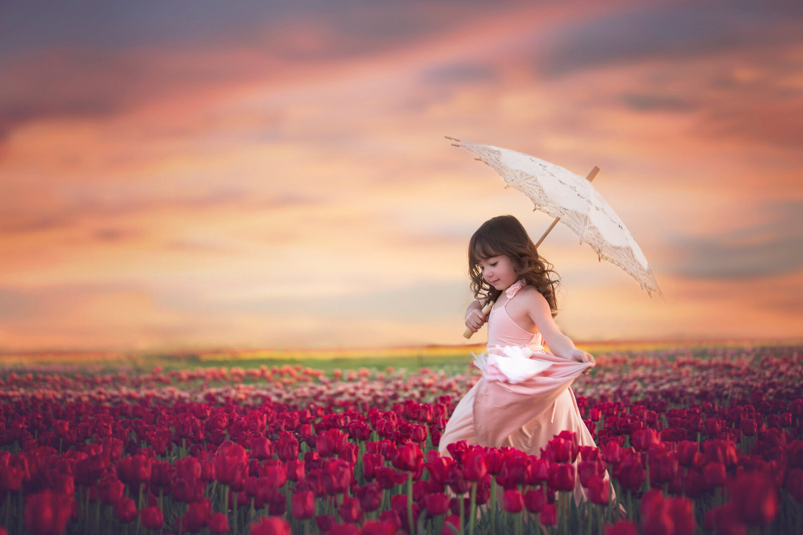 Photo of child playing in tulip field in Texas