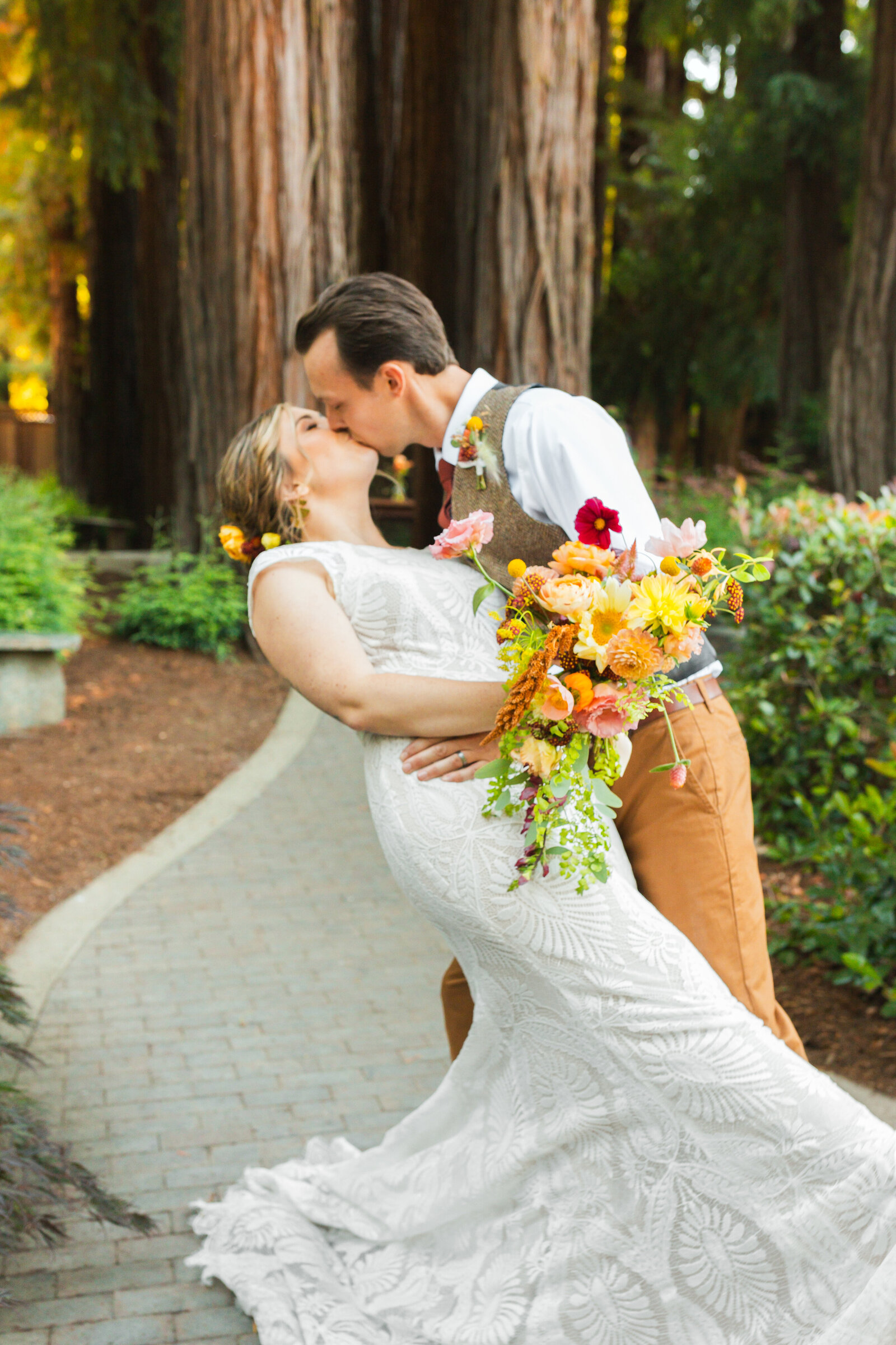 Bride and groom on their colorful wedding day in Santa Cruz, California in the redwood trees.