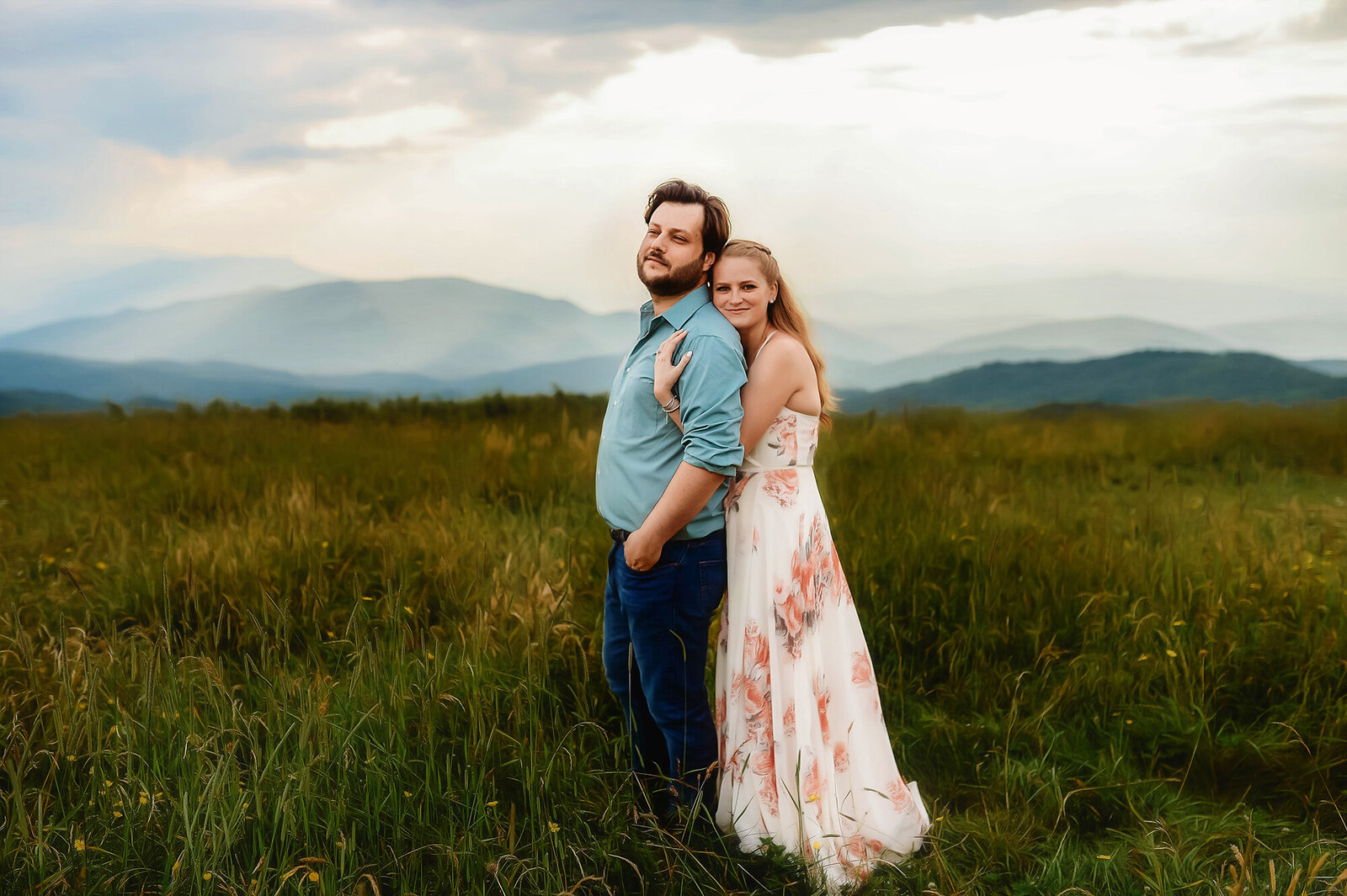 Engaged couple poses for Engagement Photos at Max Patch mountain near Asheville, NC.