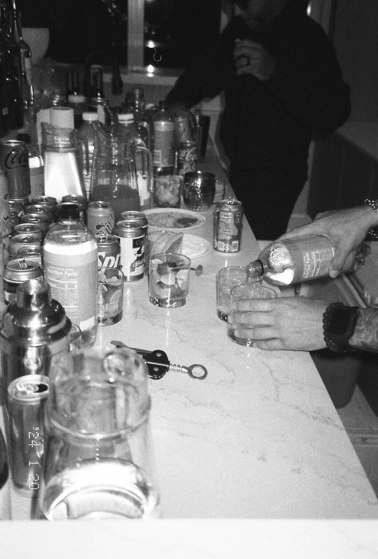 Bartender serving drinks for the guests of the wedding during cocktail hour after the wedding on film