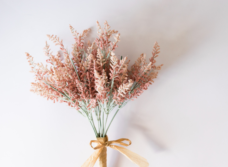 bouquet of long pink flowers in a white room