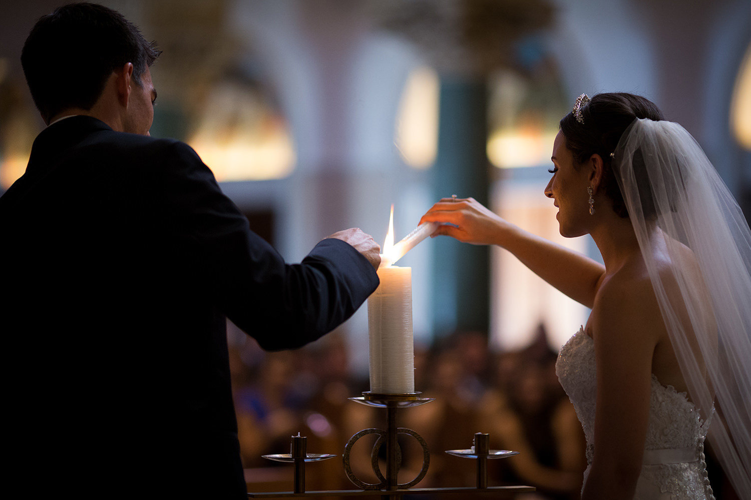 bride and groom lighting candles at the immaculata