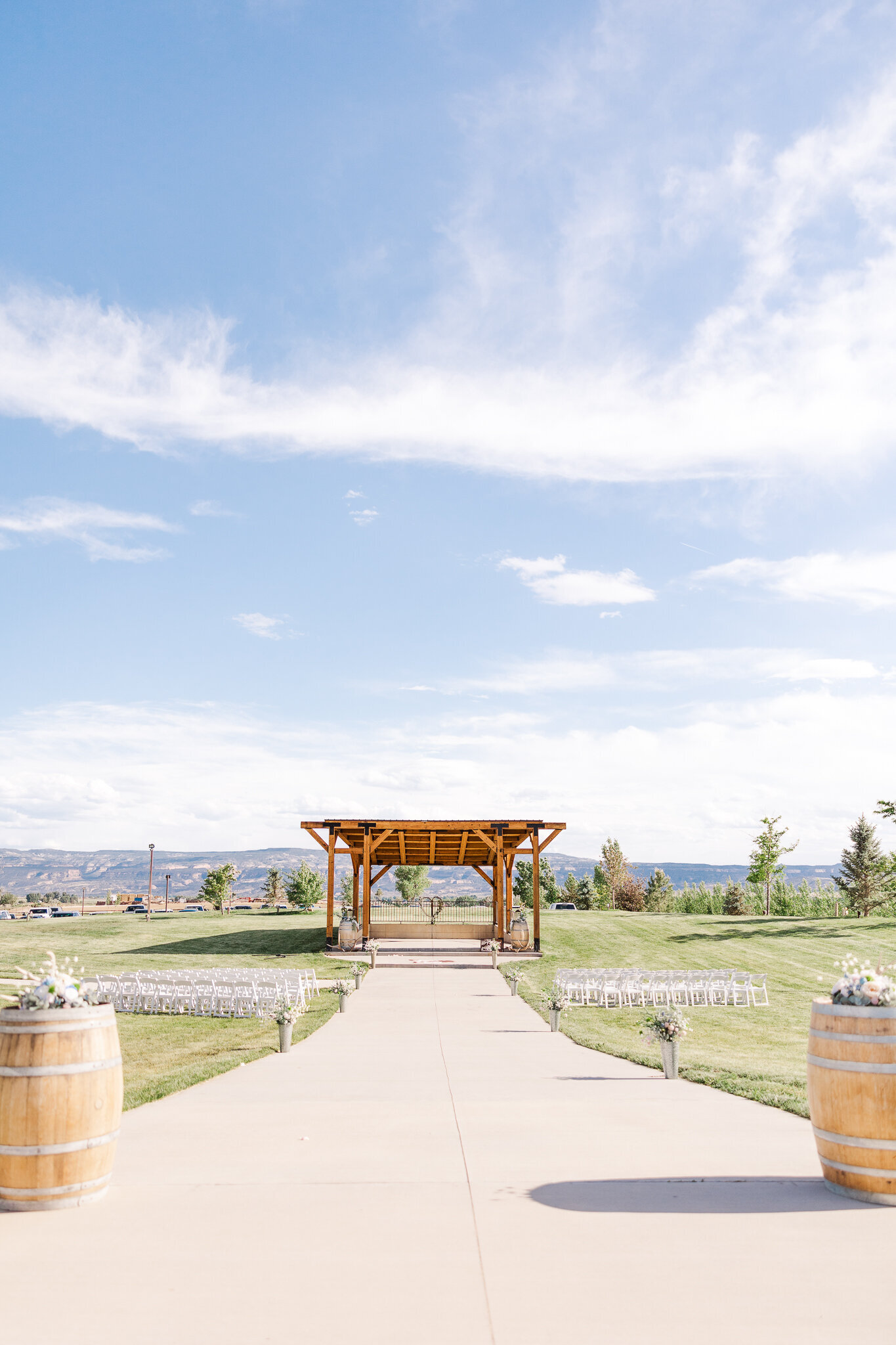 Ceremony setup at Absolute Prestige in Loma, Colorado with wooden arch and scenic mountain views in the background