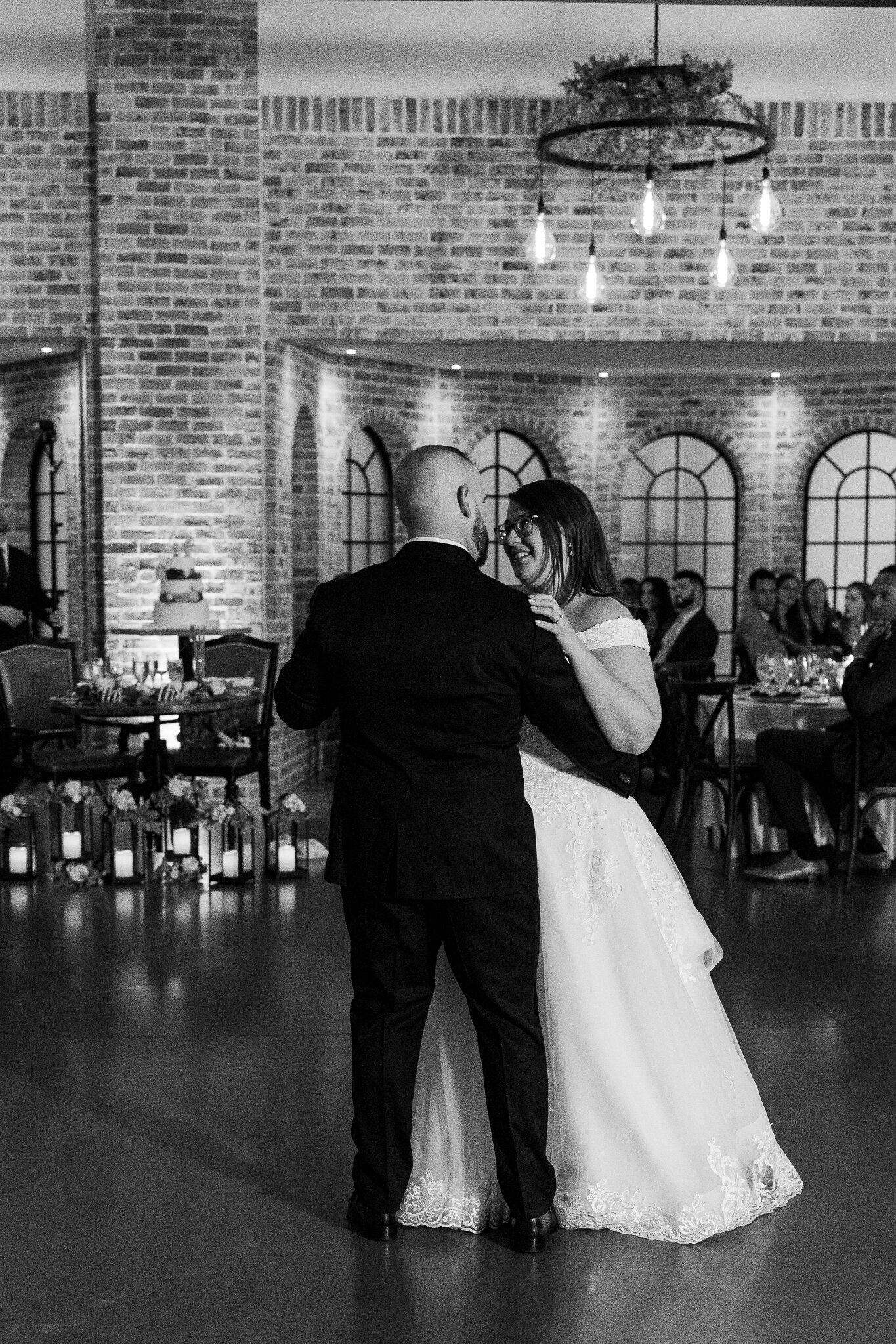 Black and white close-up of bride and groom during their first dance at Perona Farms wedding reception.