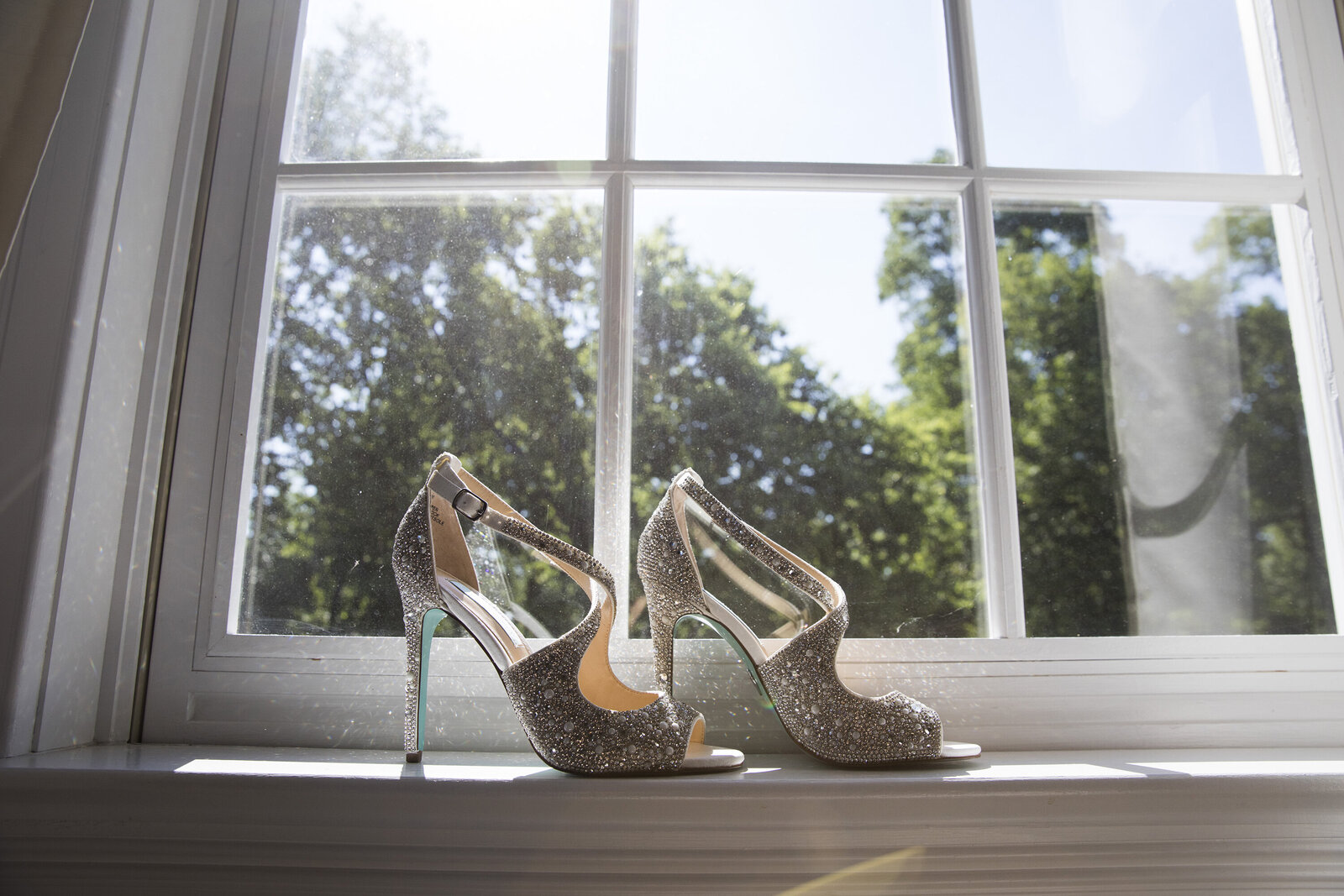 Brides Wedding shoes, placed in front of window. Private Estate Wedding New Hope Pennsylvania 
