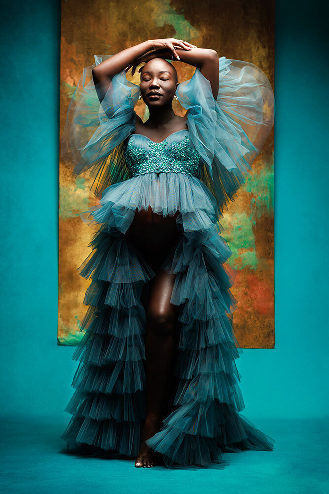 elegant-luxury-maternity-portrait-beautiful-black-woman-stunning-turquoise-dress-gold-backdrop-studio-pose-ball-gown