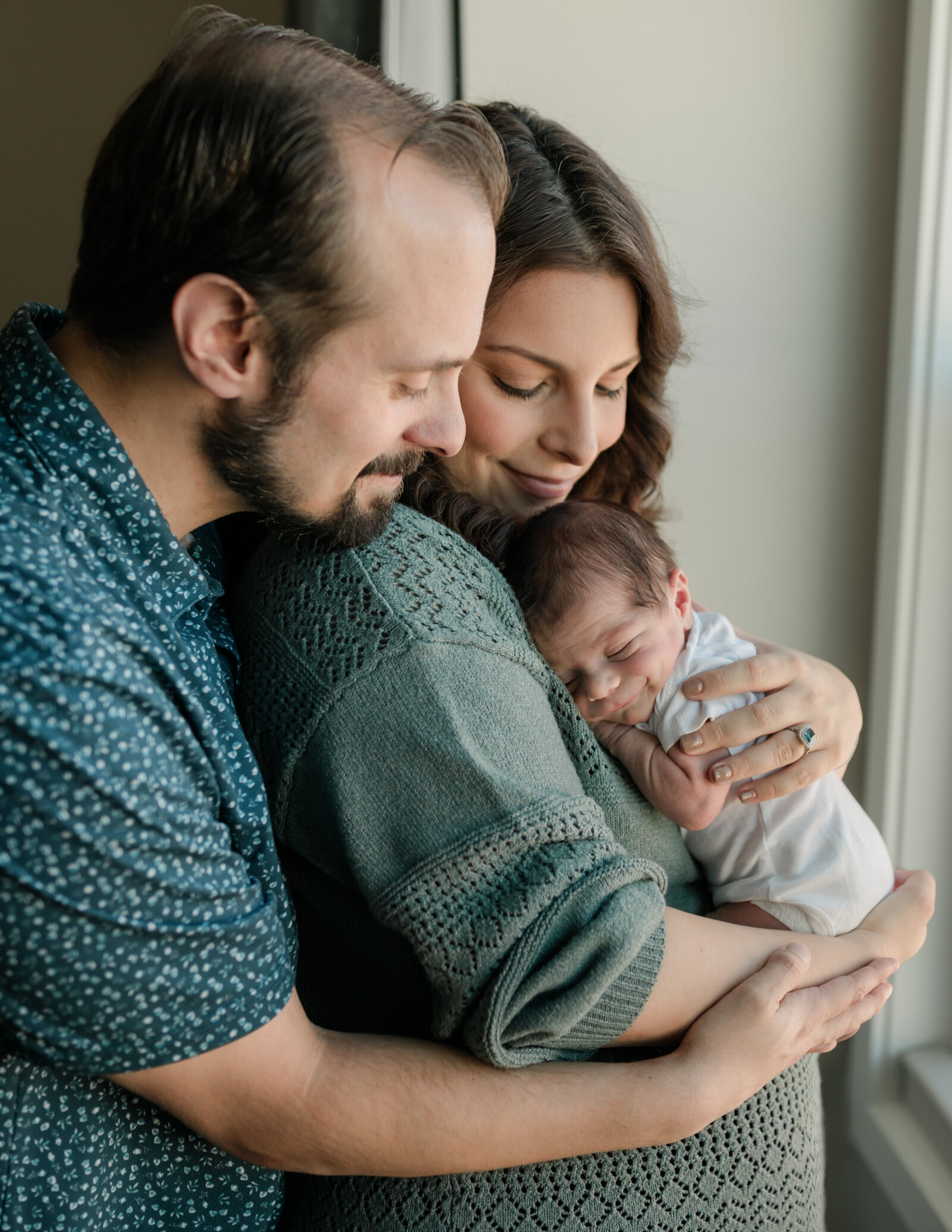 parents holding newborn baby boy for in home lifestyle session