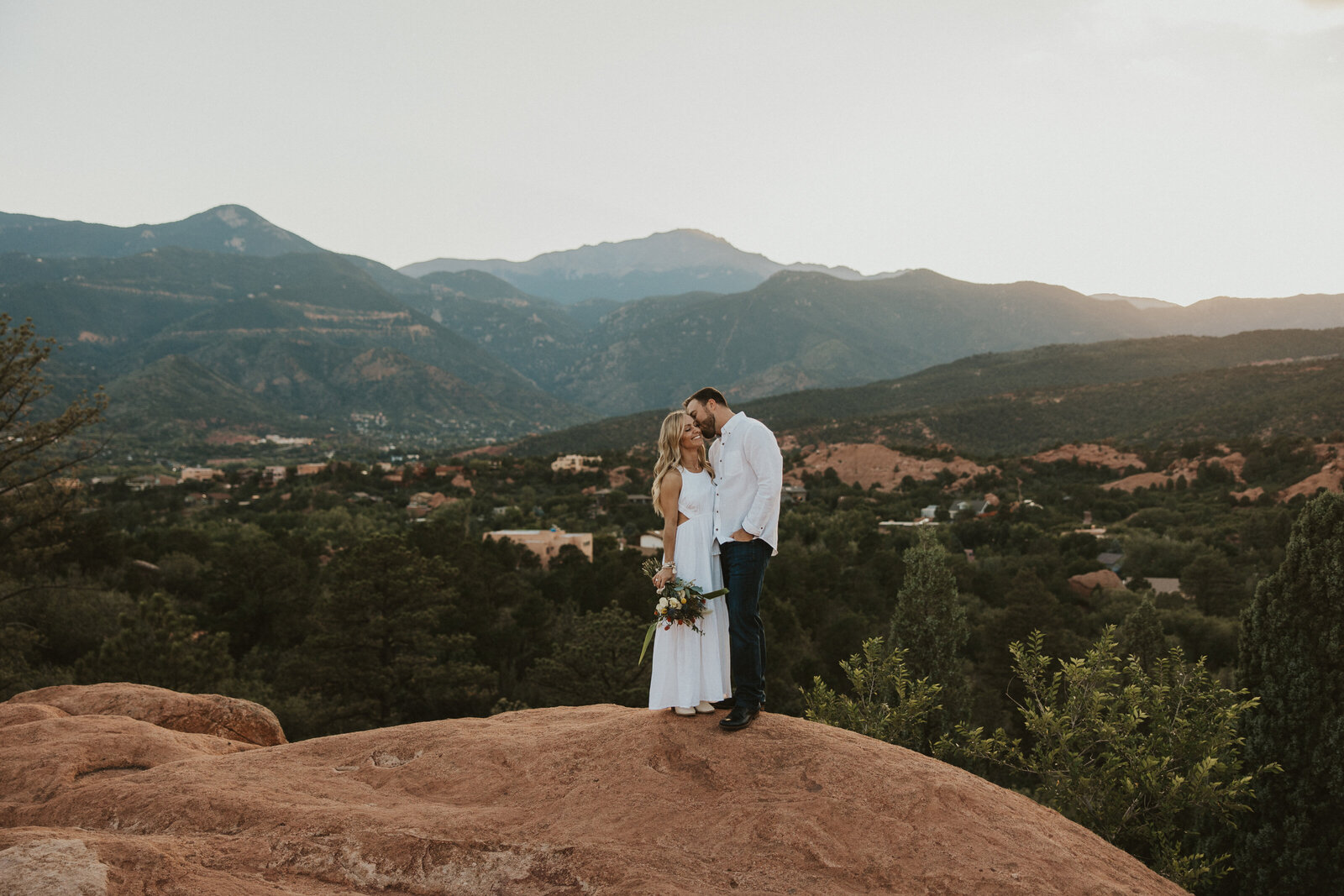 a sunset in Garden of the Gods with a couple in front of it
