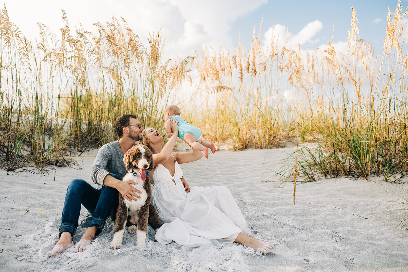 St. Pete florida family on the beach with thier dog.