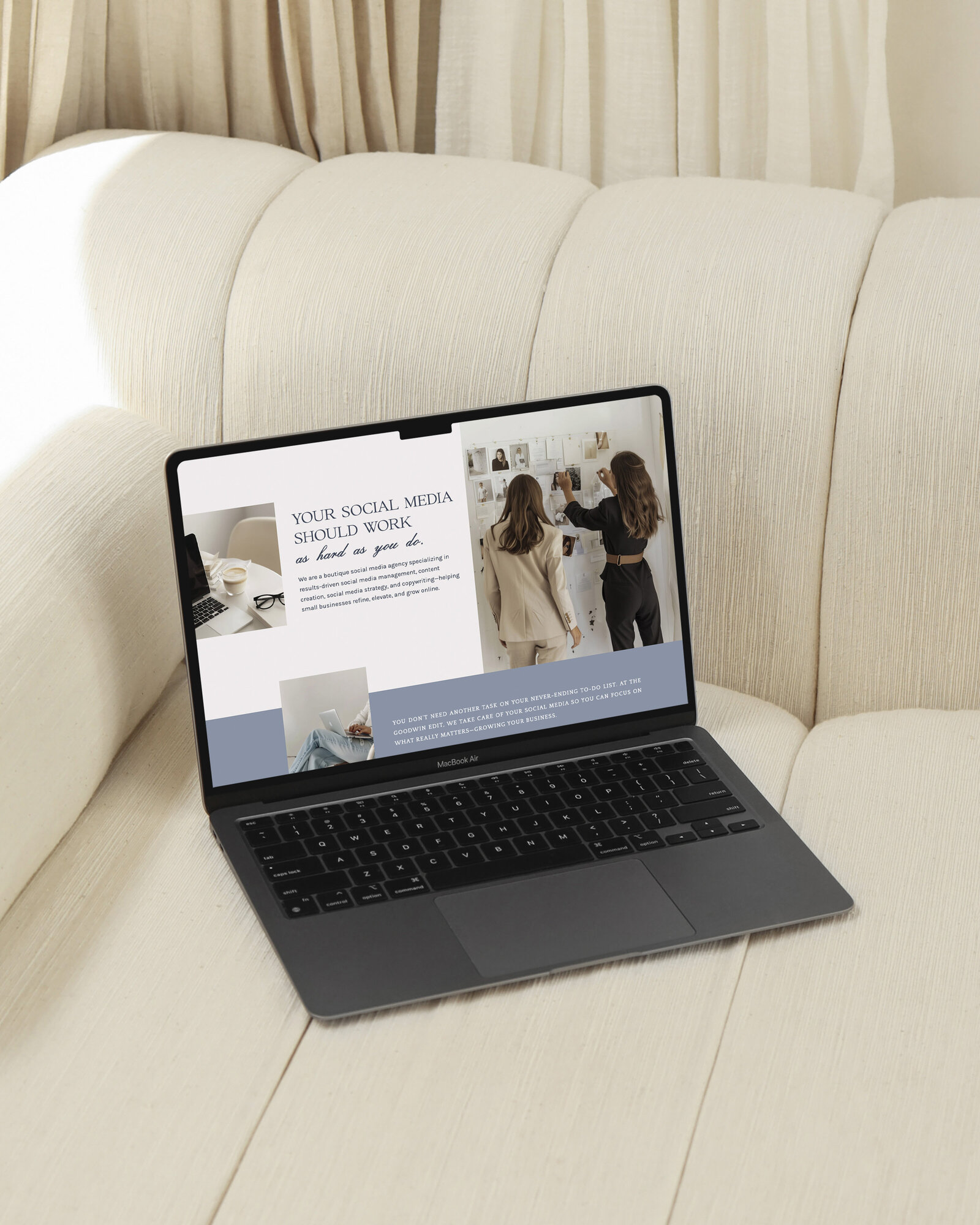 Laptop showing creative website layout on couch