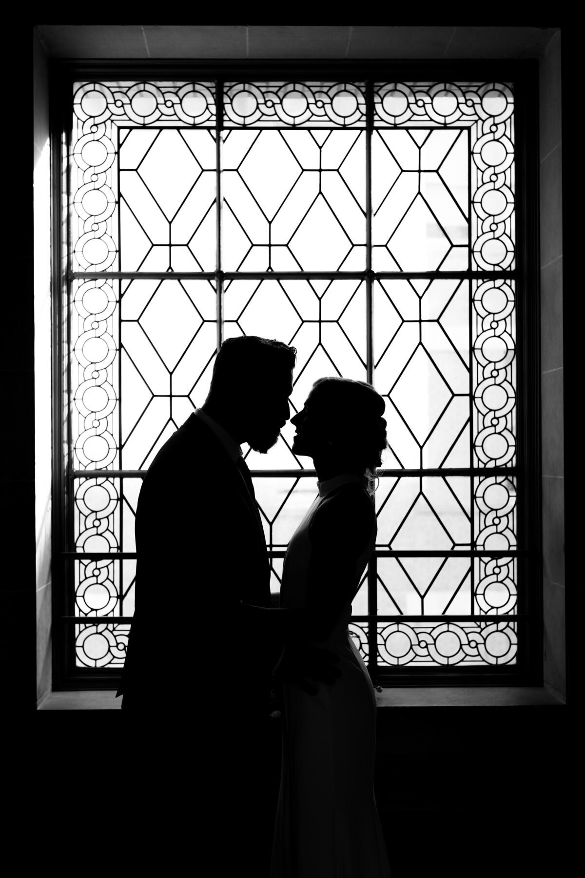 silhouetted couple on 3rd floor window of sf city hall