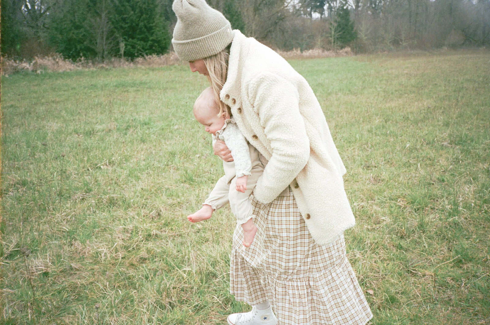 Mother in field playing with child on Sauvie Island in Portland, Oregon.