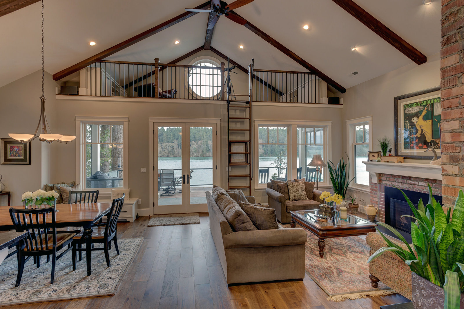 living and dining areas with vaulted exposed beam ceilings