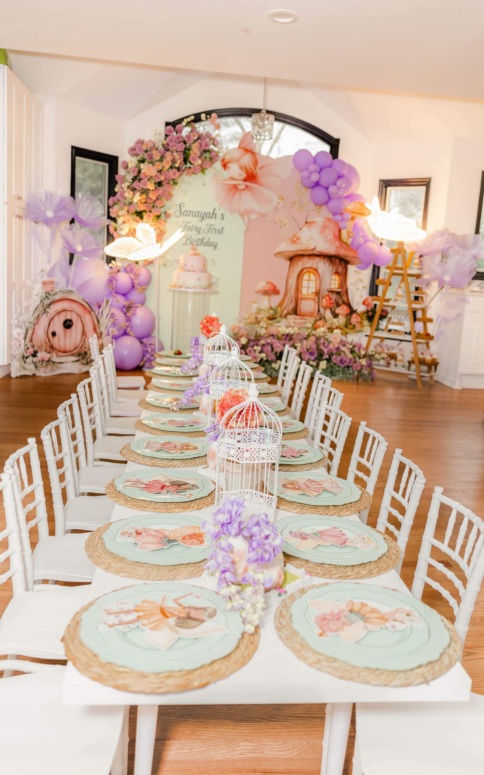 Whimsical fairy-themed birthday party table setup with floral decorations and custom fairy plates, captured by a Long Island event photographer
