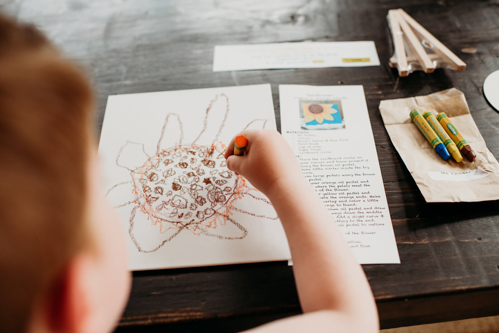 Branding Photographer,  a child draws a picture of a flower with crayons