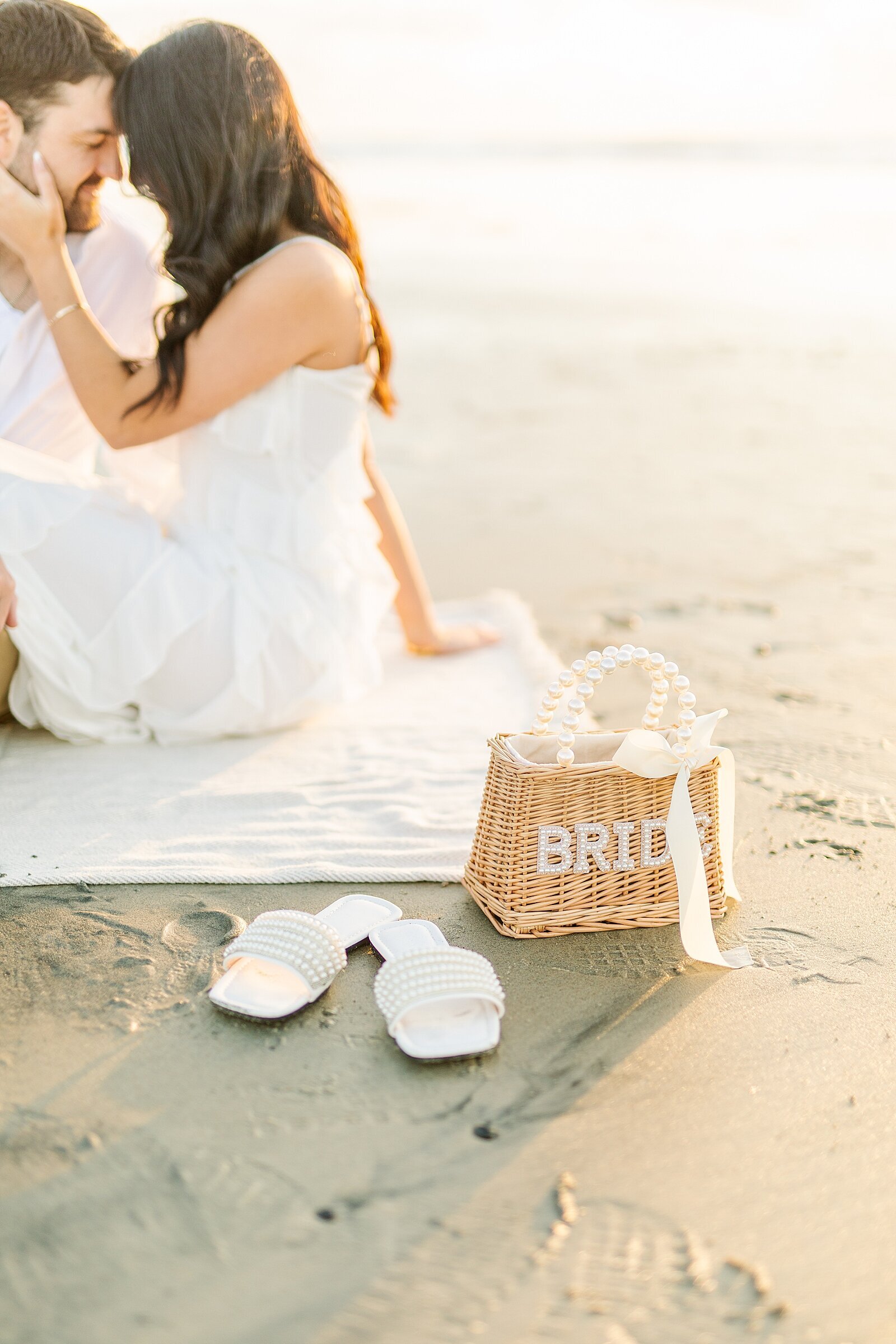 Bride's whicker and pearl purse on the beach of Del Mar.