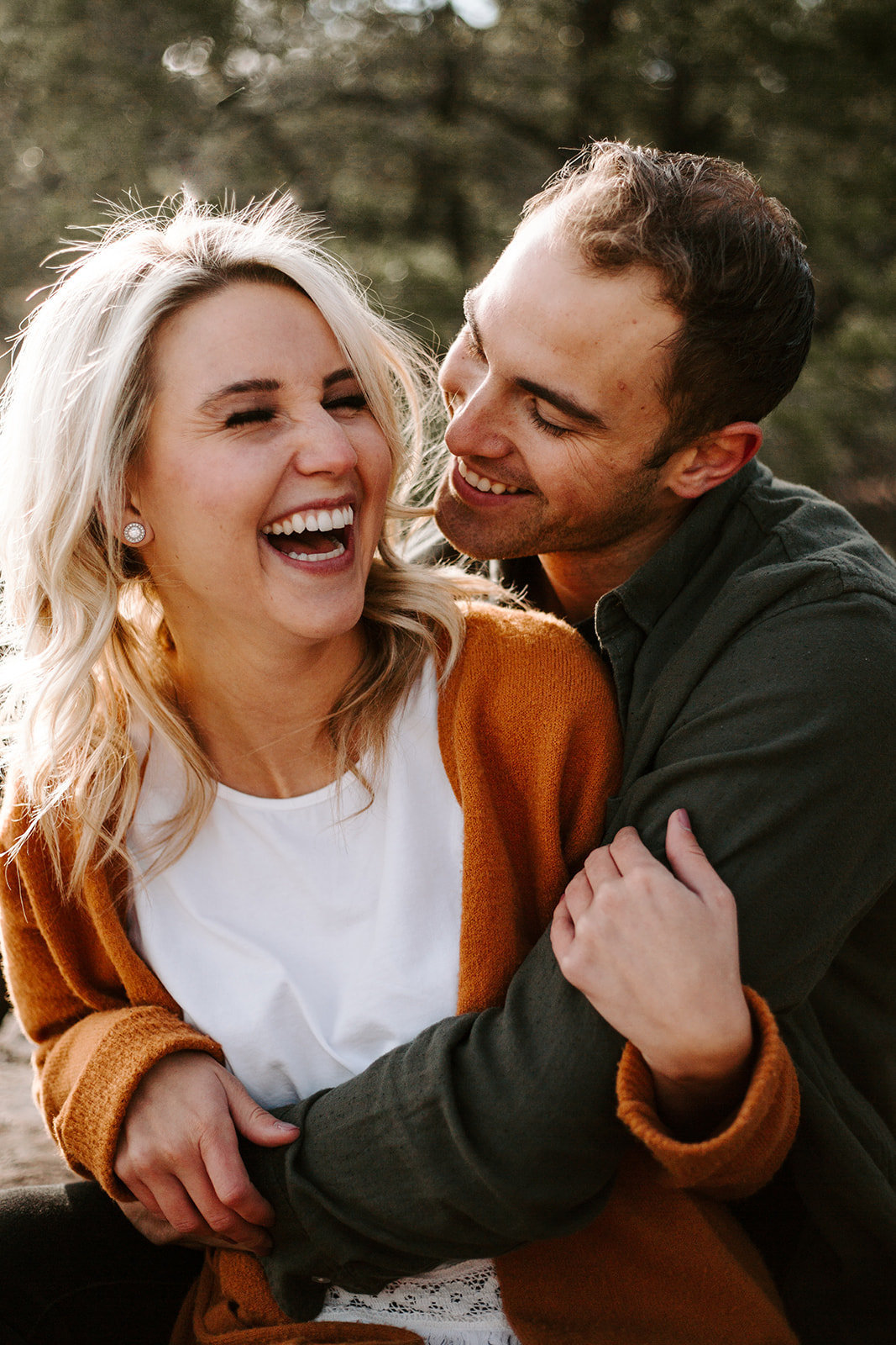 Couple laughing together while the guy hugs the girl from behind during their Minneapolis Engagement session