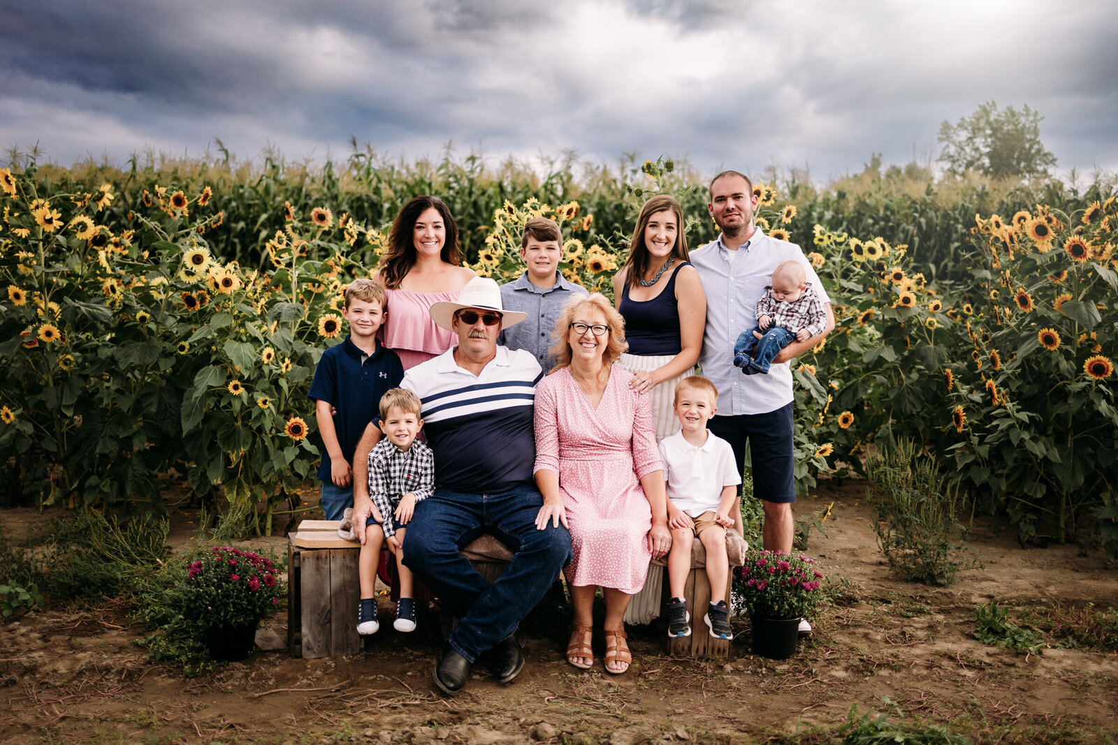 Large family portrait in front of sunflower field at Mason Farms Erie, PA