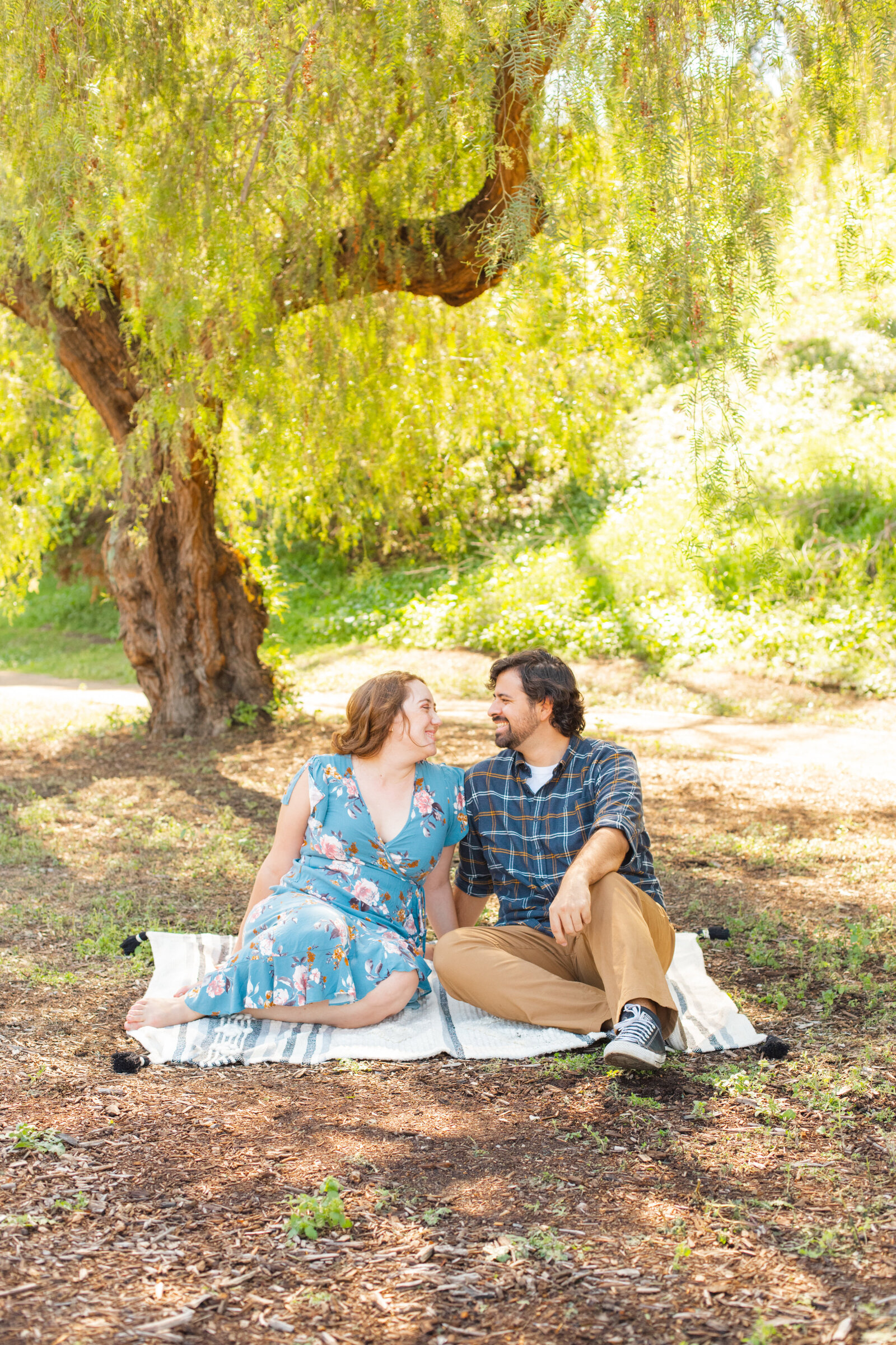 An engaged couple poses for photos in a garden in Los Angeles, Ca.