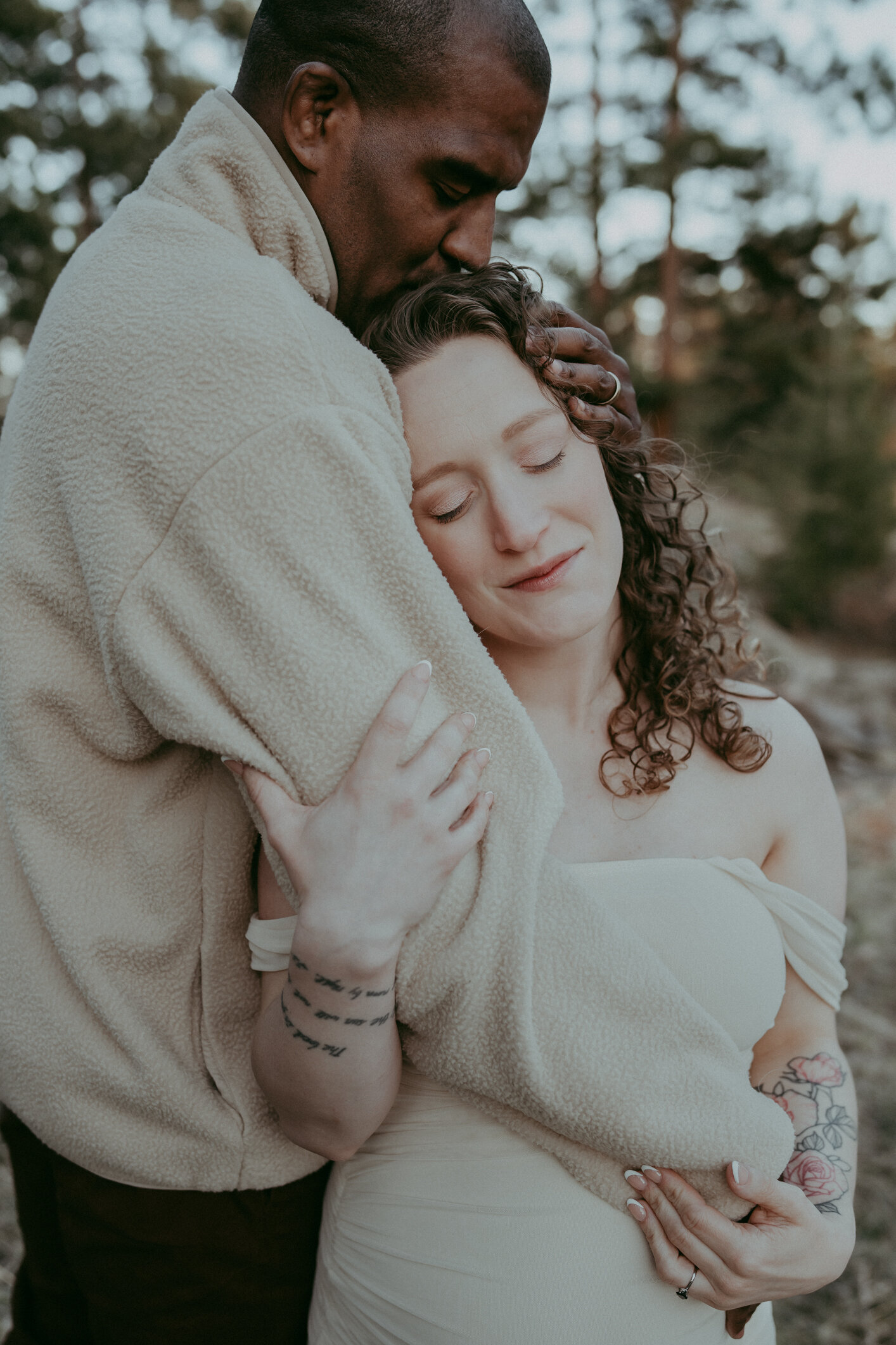 husband kisses top of wifes head