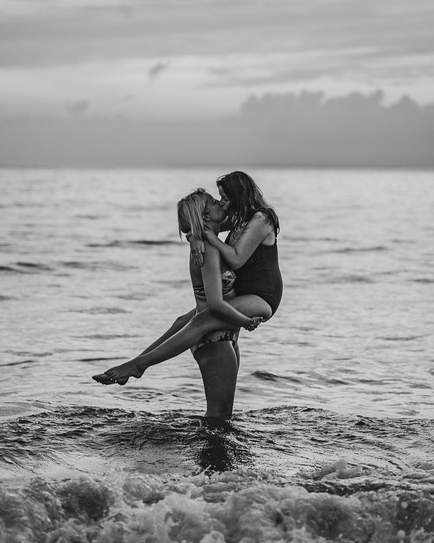 female couple kiss in the sea